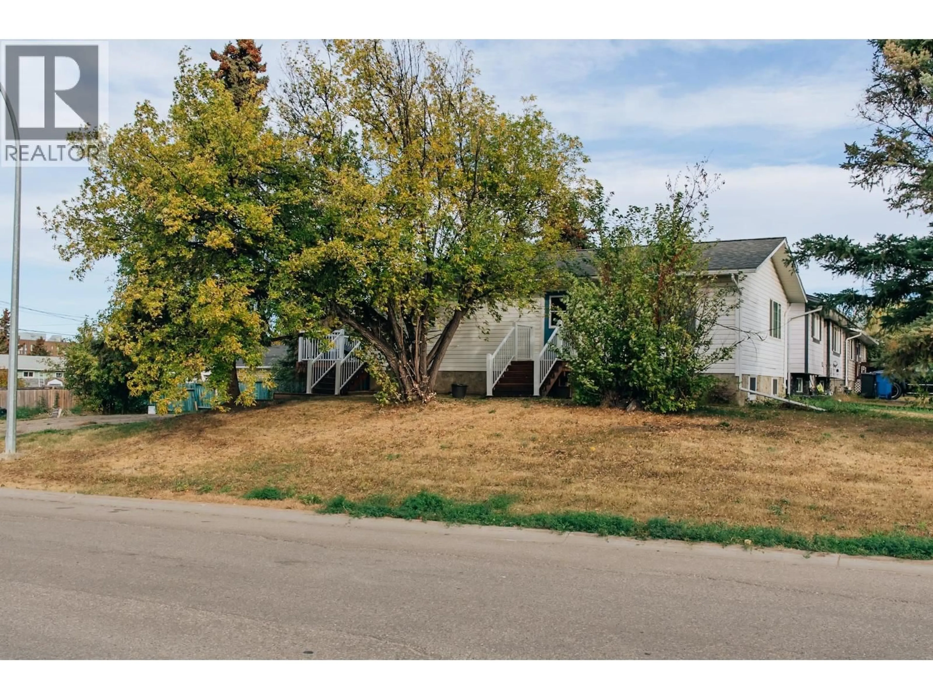 A pic from outside/outdoor area/front of a property/back of a property/a pic from drone, street for 9004 91 AVENUE, Fort St. John British Columbia V1J4W4