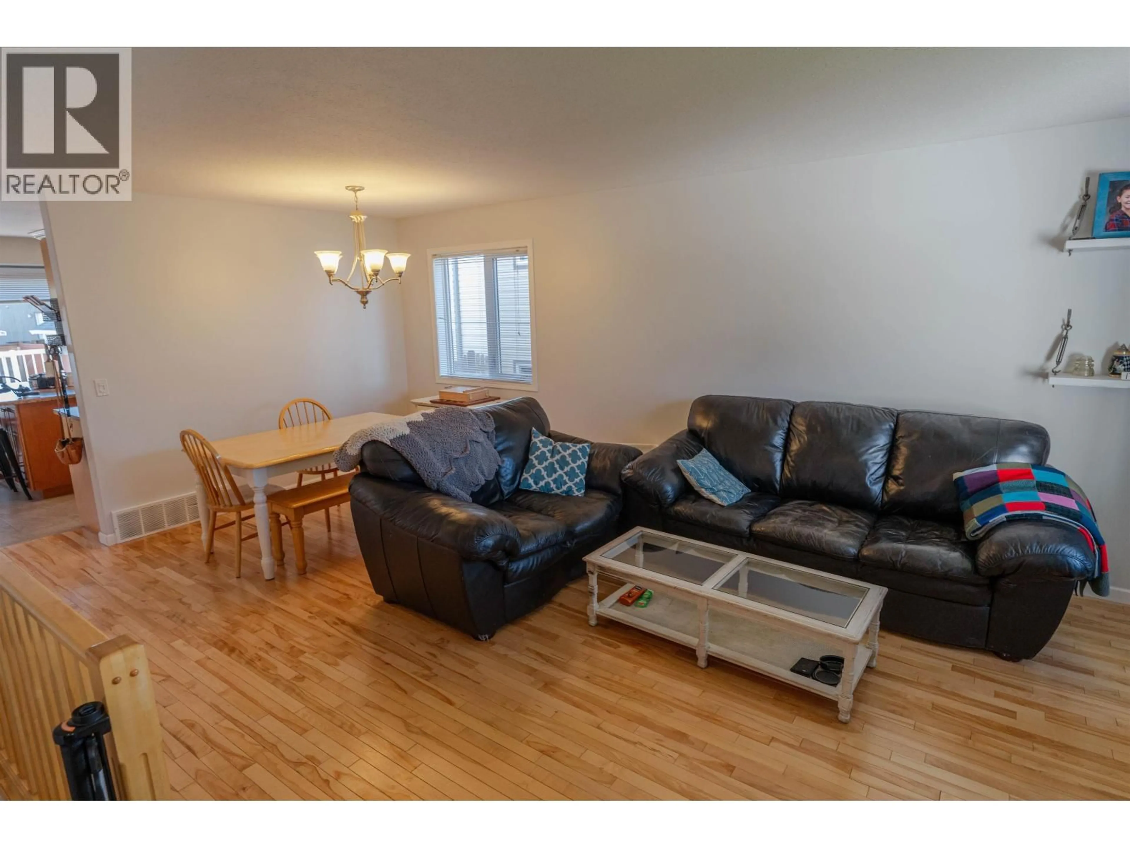 Living room with furniture, wood/laminate floor for 11723 91 STREET, Fort St. John British Columbia V1J0B3
