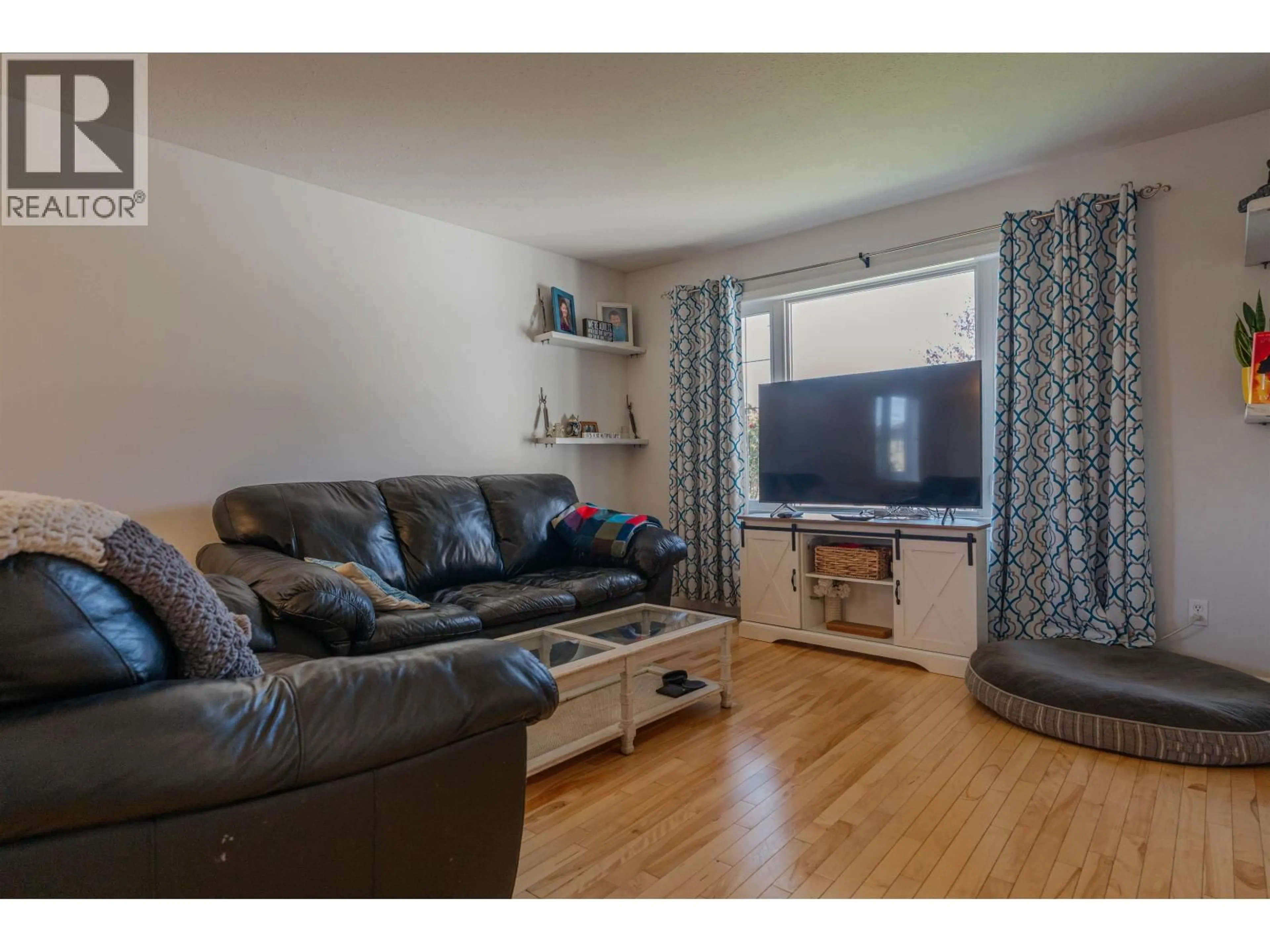 Living room with furniture, wood/laminate floor for 11723 91 STREET, Fort St. John British Columbia V1J0B3