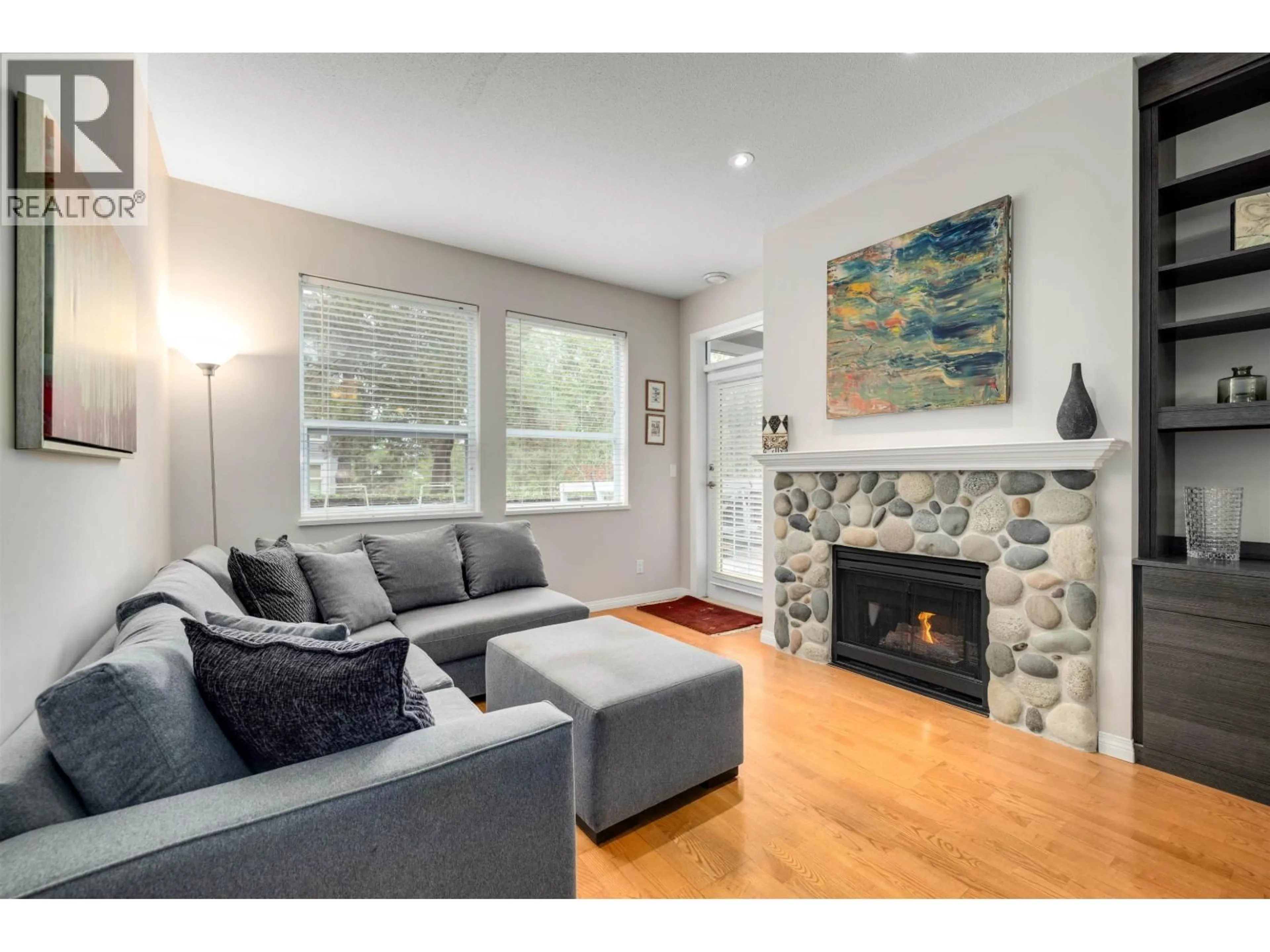 Living room with furniture, wood/laminate floor for 121 - 12931 RAILWAY AVENUE, Richmond British Columbia V7E6M5