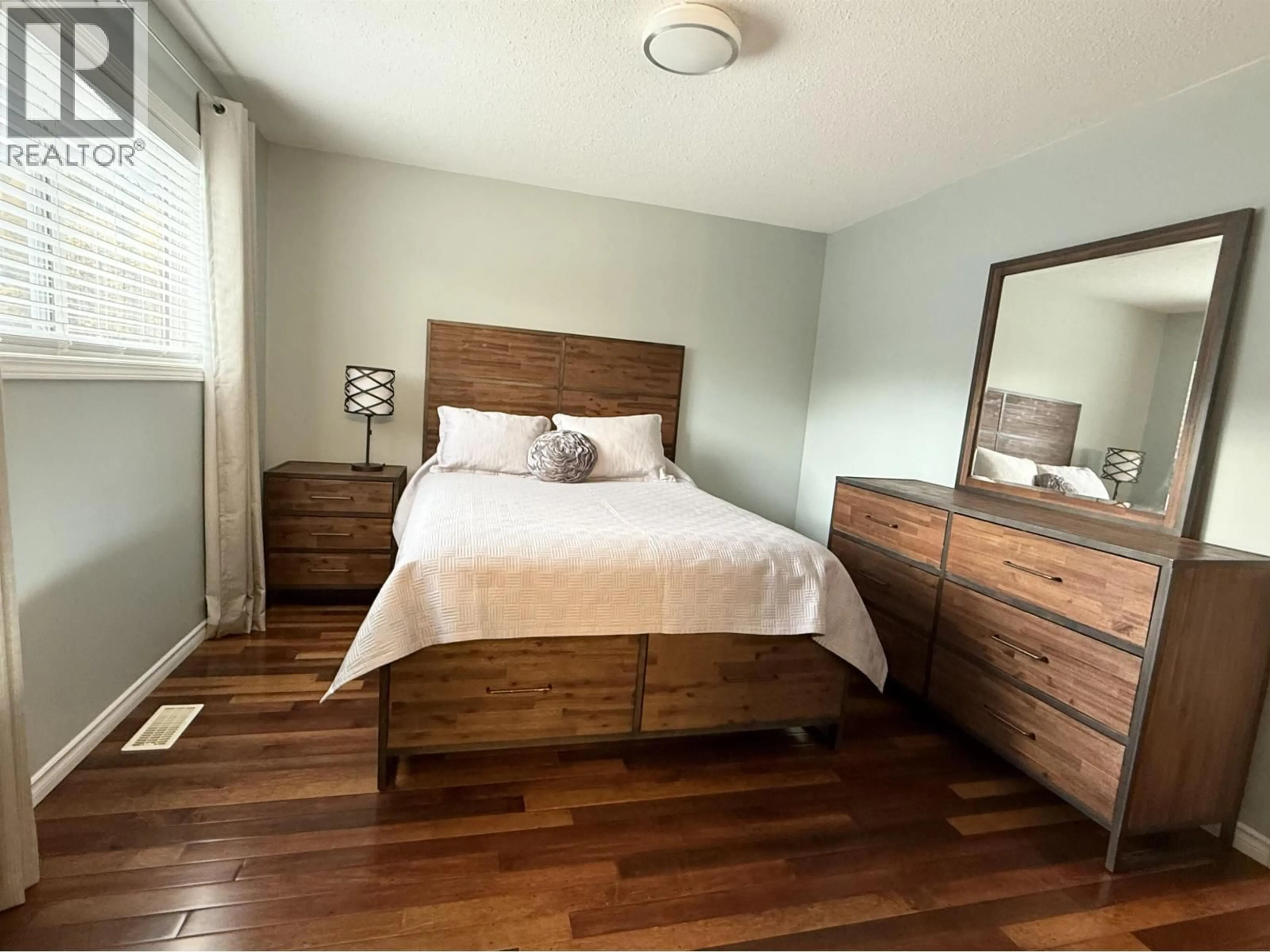 Bedroom with bed, wood/laminate floor for 105 - 7180 ST LAWRENCE AVENUE, Prince George British Columbia V2N5C6