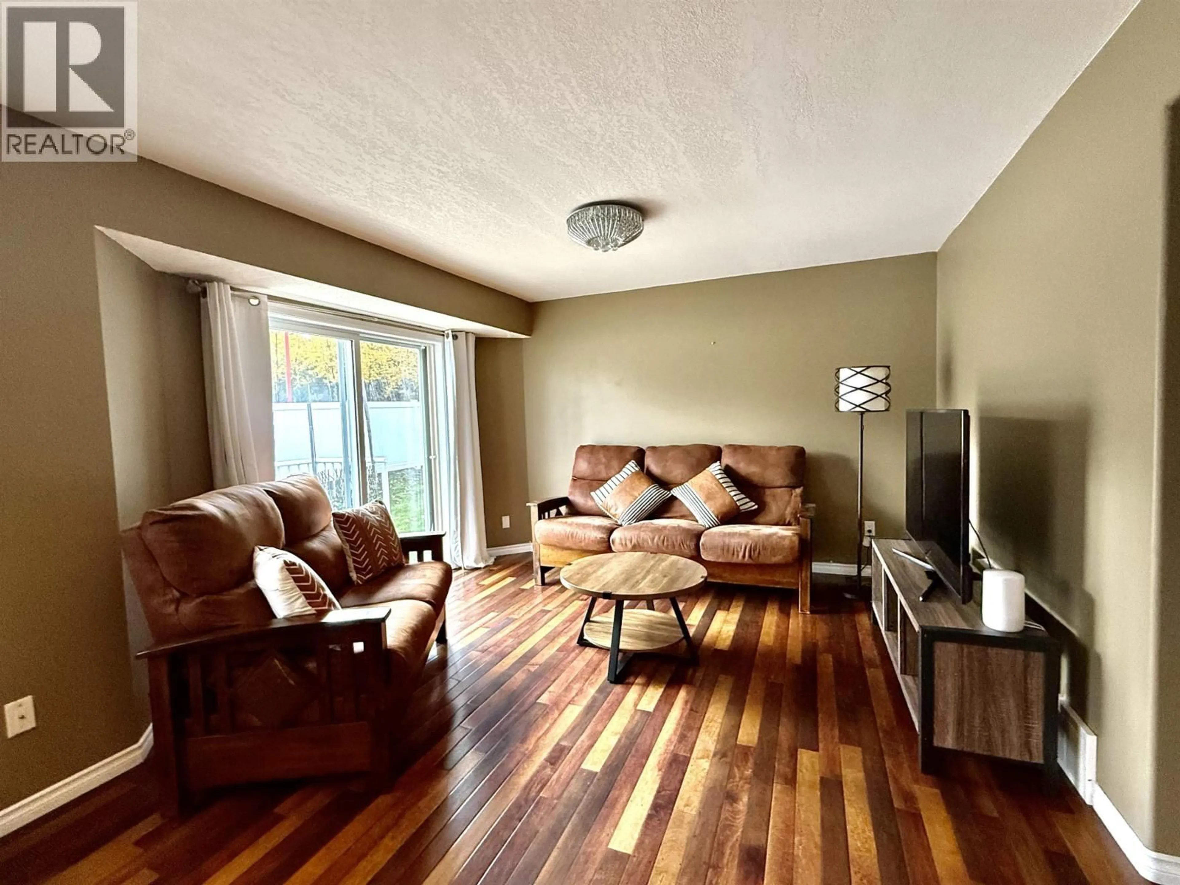 Living room with furniture, wood/laminate floor for 105 - 7180 ST LAWRENCE AVENUE, Prince George British Columbia V2N5C6
