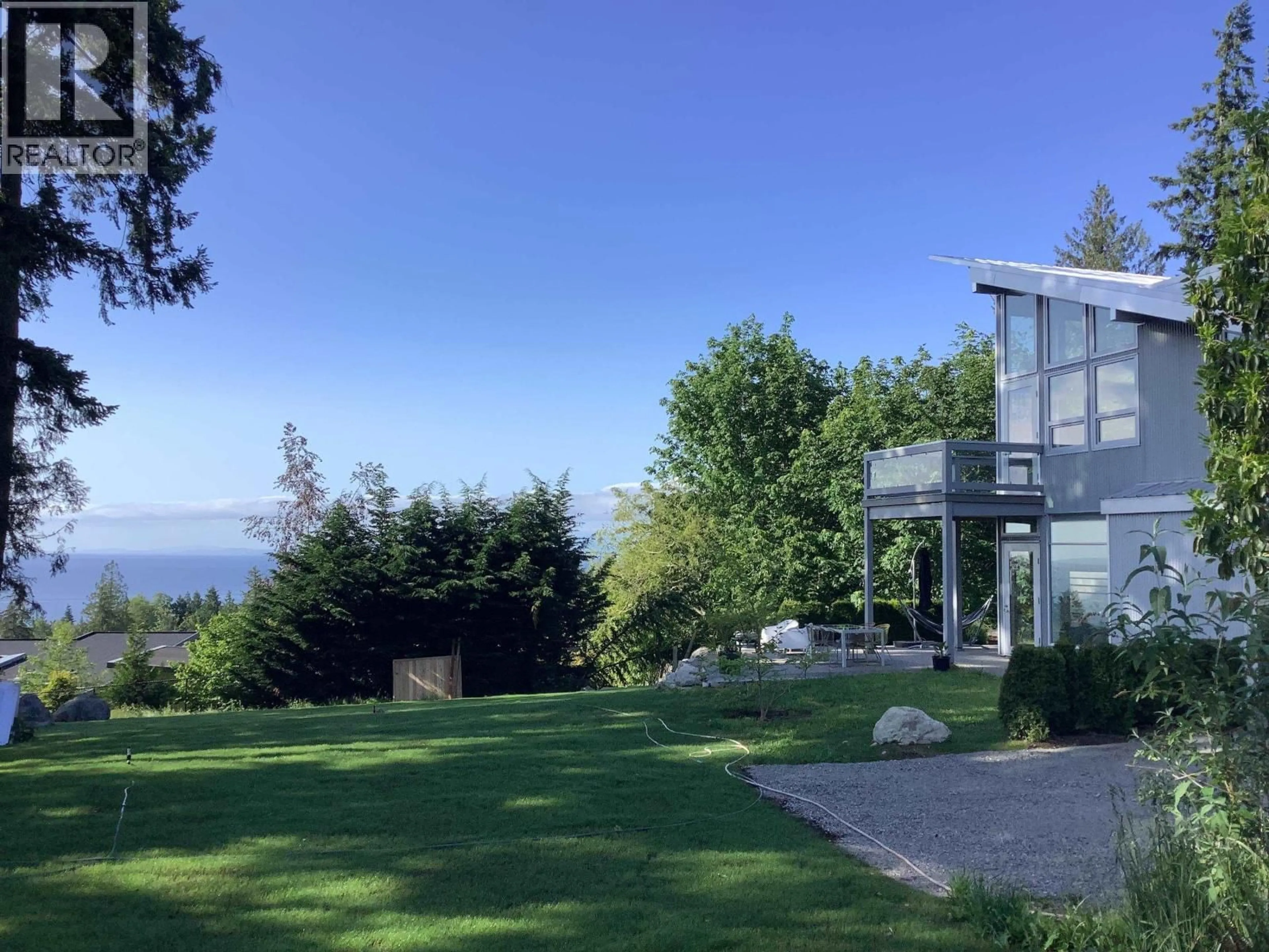 A pic from outside/outdoor area/front of a property/back of a property/a pic from drone, water/lake/river/ocean view for 5550 NICKERSON ROAD, Sechelt British Columbia V7Z0M4