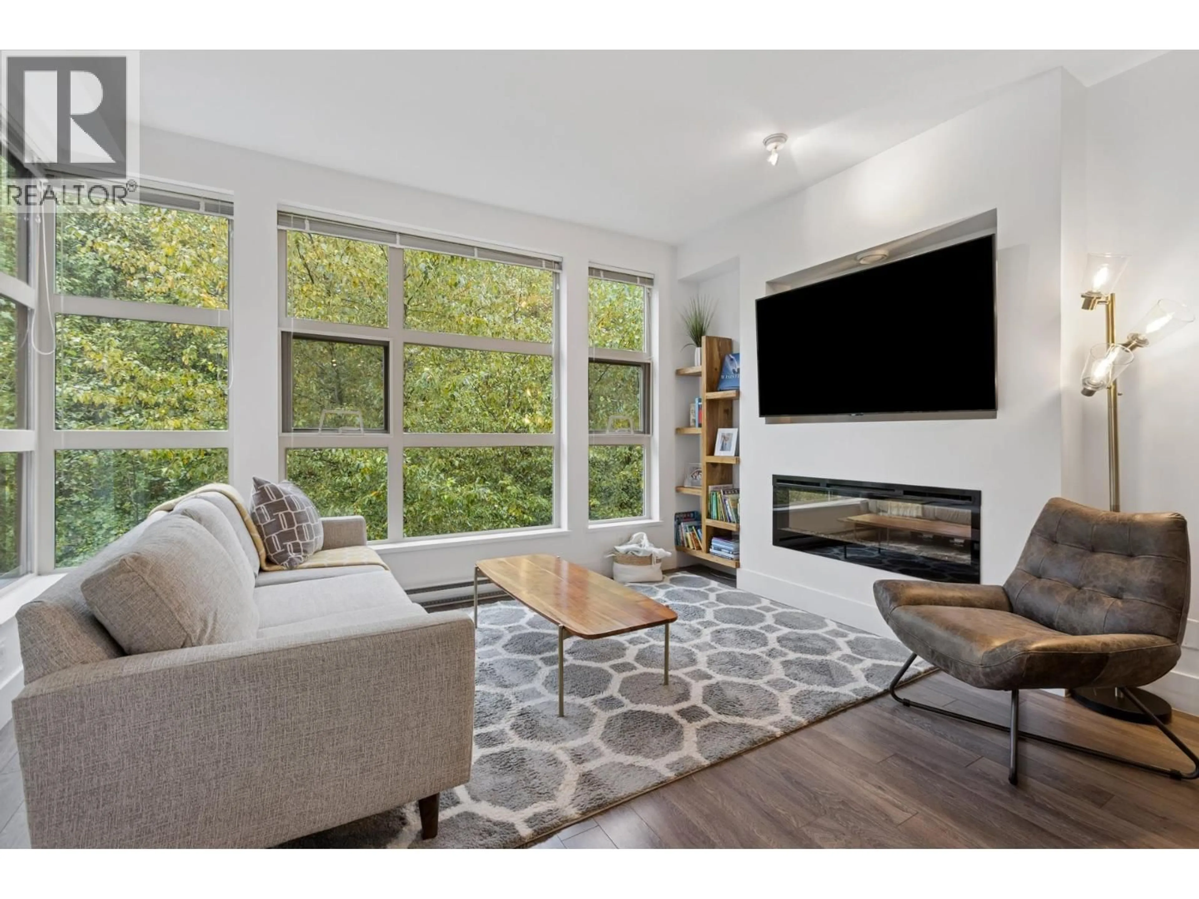 Living room with furniture, wood/laminate floor for 406 - 3606 ALDERCREST DRIVE, North Vancouver British Columbia V7G0A3