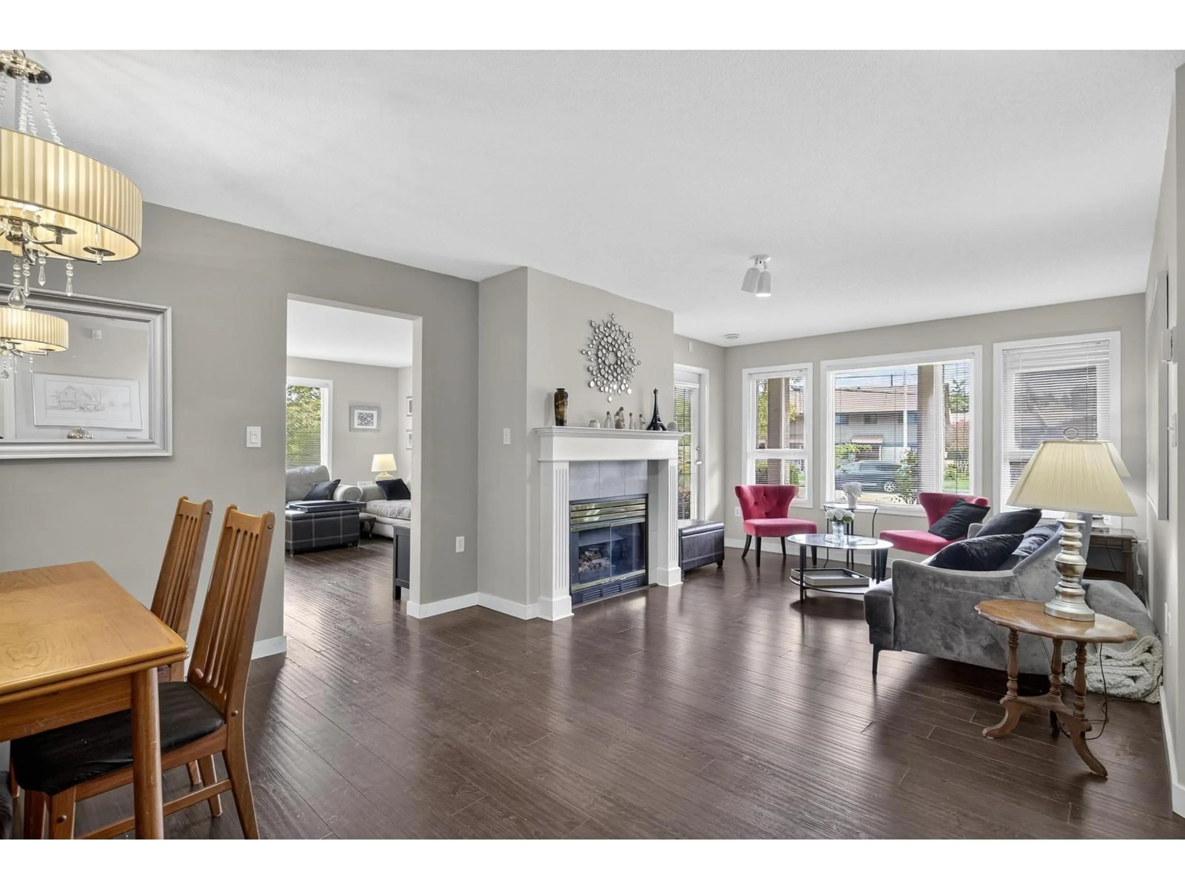 Living room with furniture, wood/laminate floor for 107 - 17740 58A, Surrey British Columbia V3S8M5