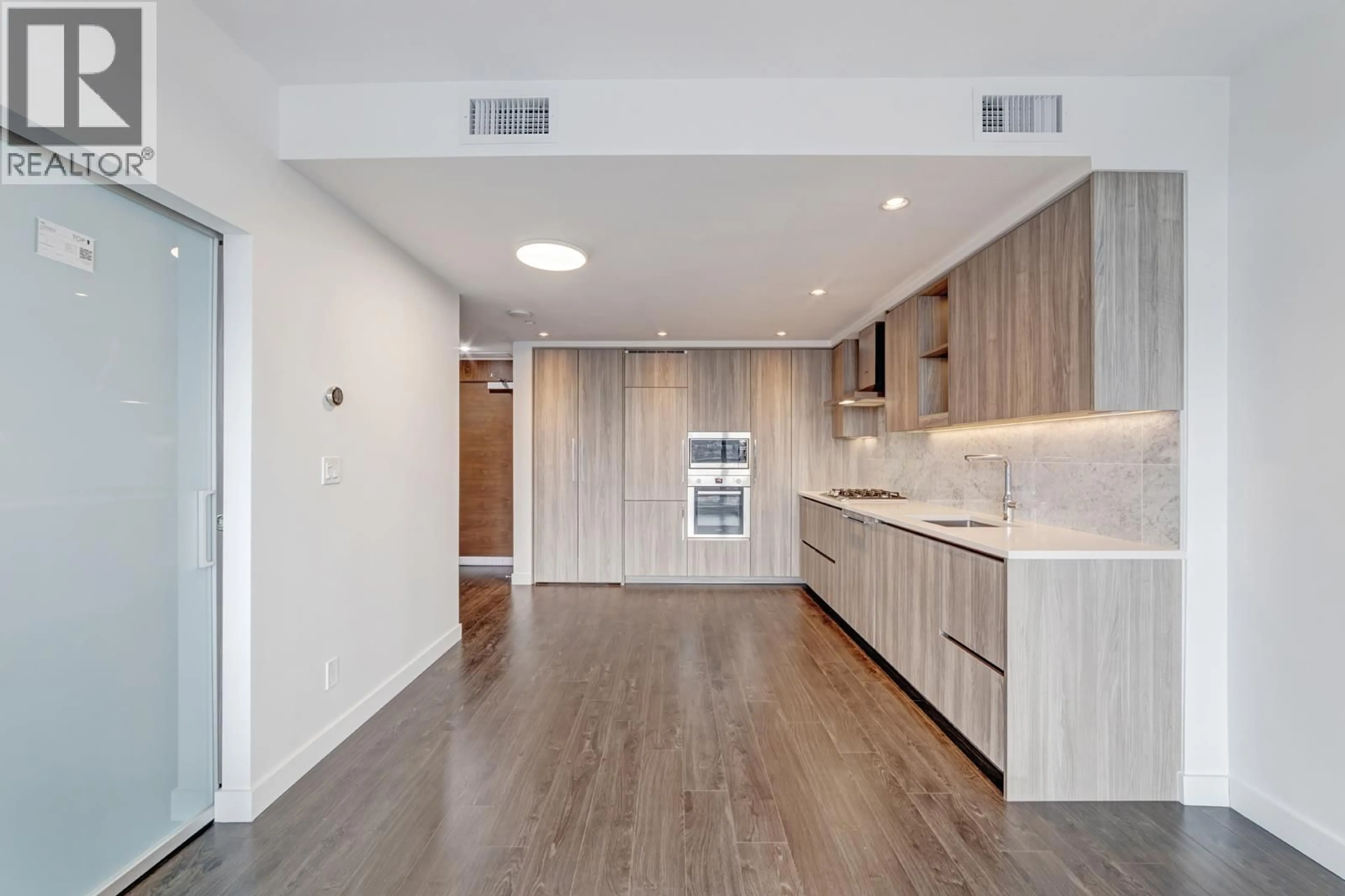Open concept kitchen, wood/laminate floor for 410 - 4720 LOUGHEED HIGHWAY, Burnaby British Columbia V5C0M8