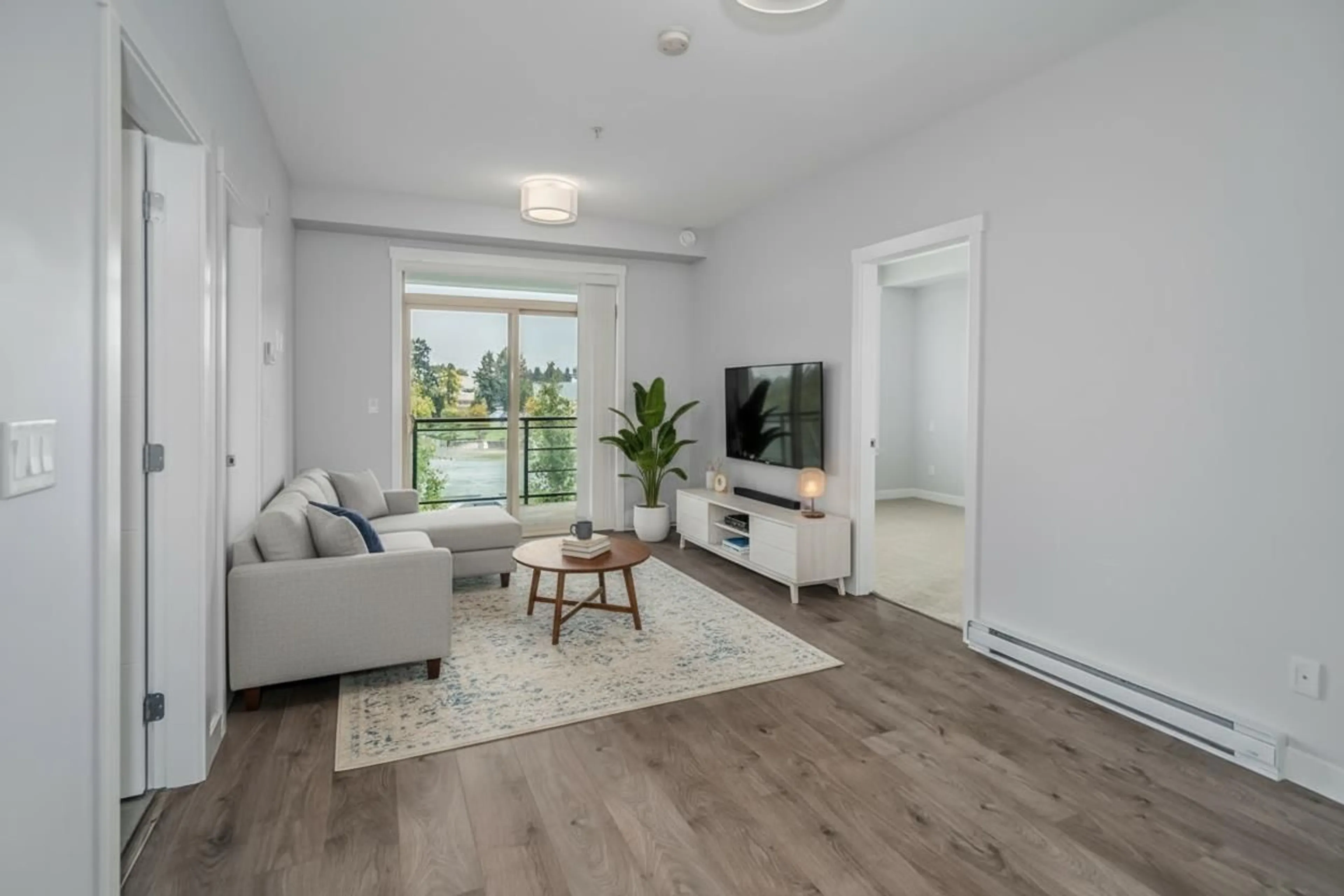Living room with furniture, wood/laminate floor for 303 - 45562 AIRPORT ROAD, Chilliwack British Columbia V2P0J8