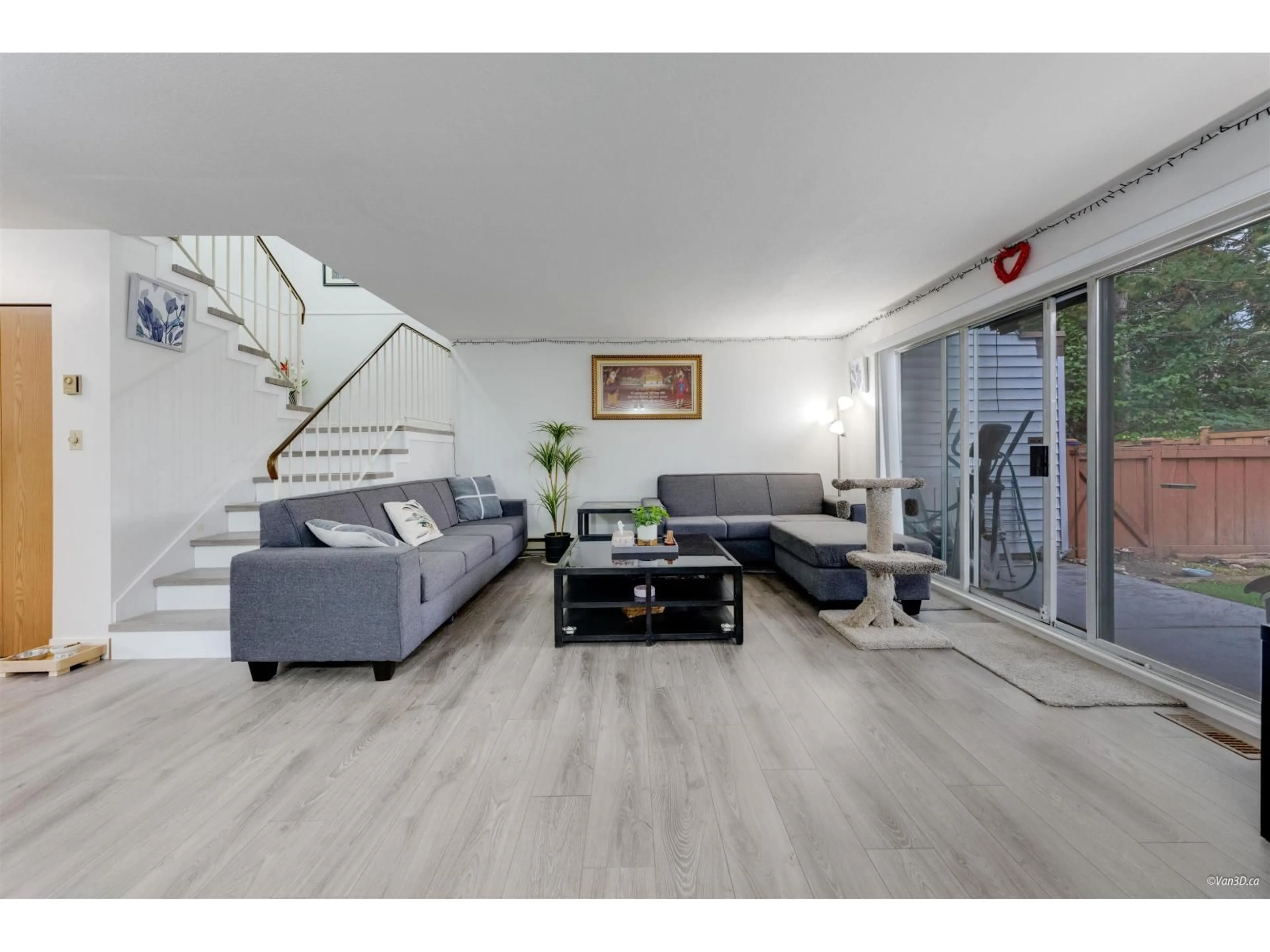 Living room with furniture, wood/laminate floor for 10 - 7540 138, Surrey British Columbia V3W9M5