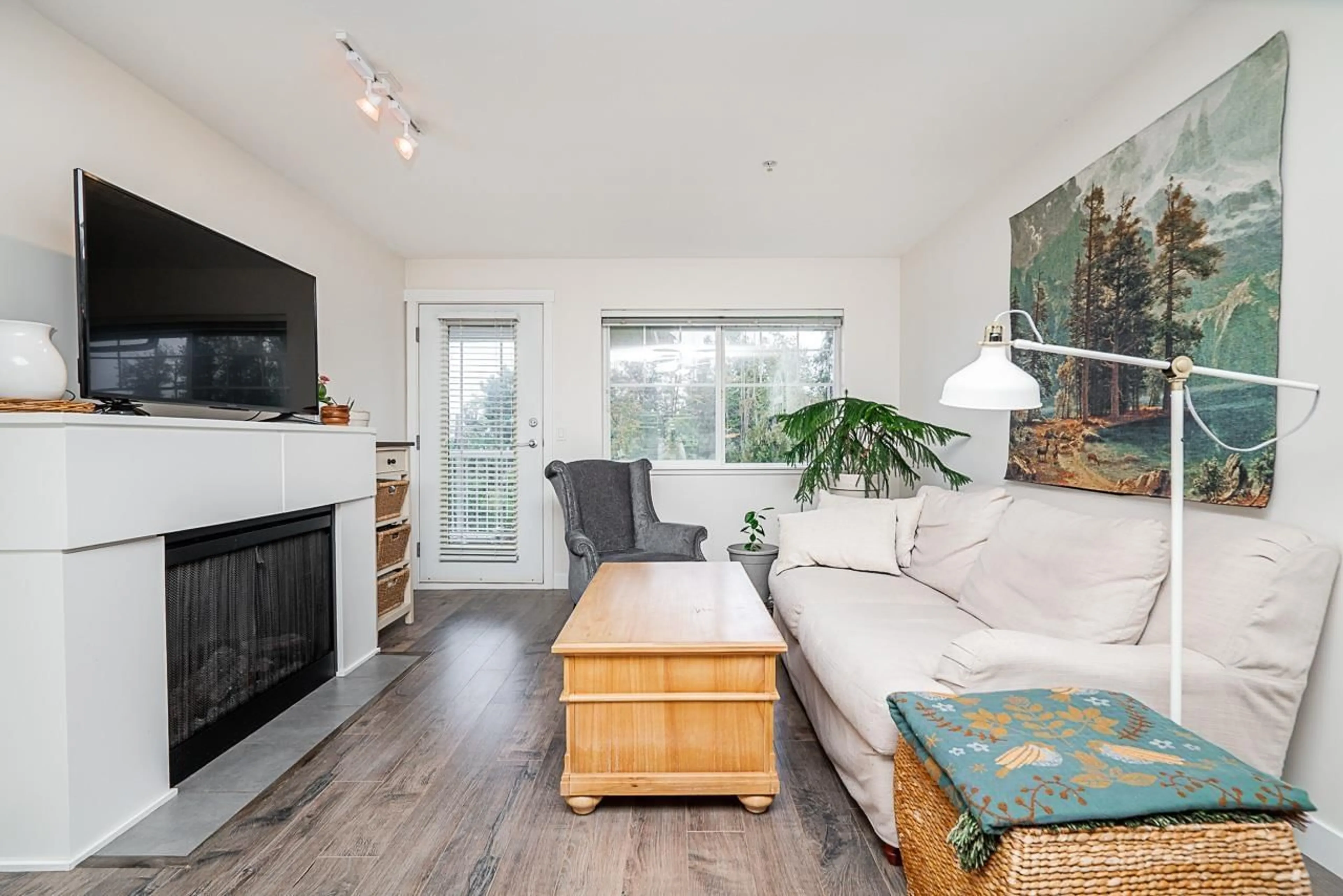 Living room with furniture, wood/laminate floor for 309 - 19388 65, Surrey British Columbia V4N5S1