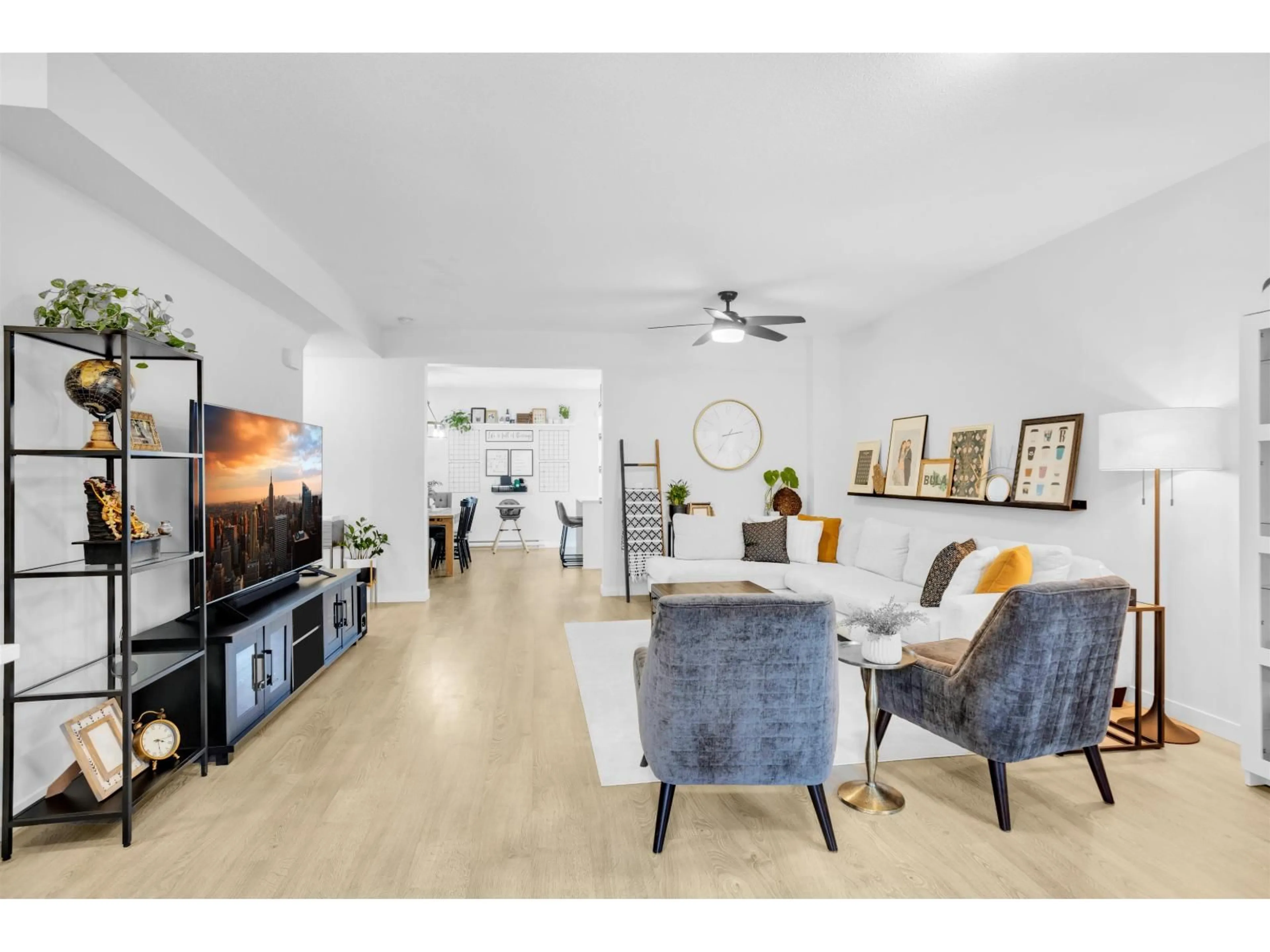 Living room with furniture, wood/laminate floor for 107 - 15111 EDMUND, Surrey British Columbia V3S0A5