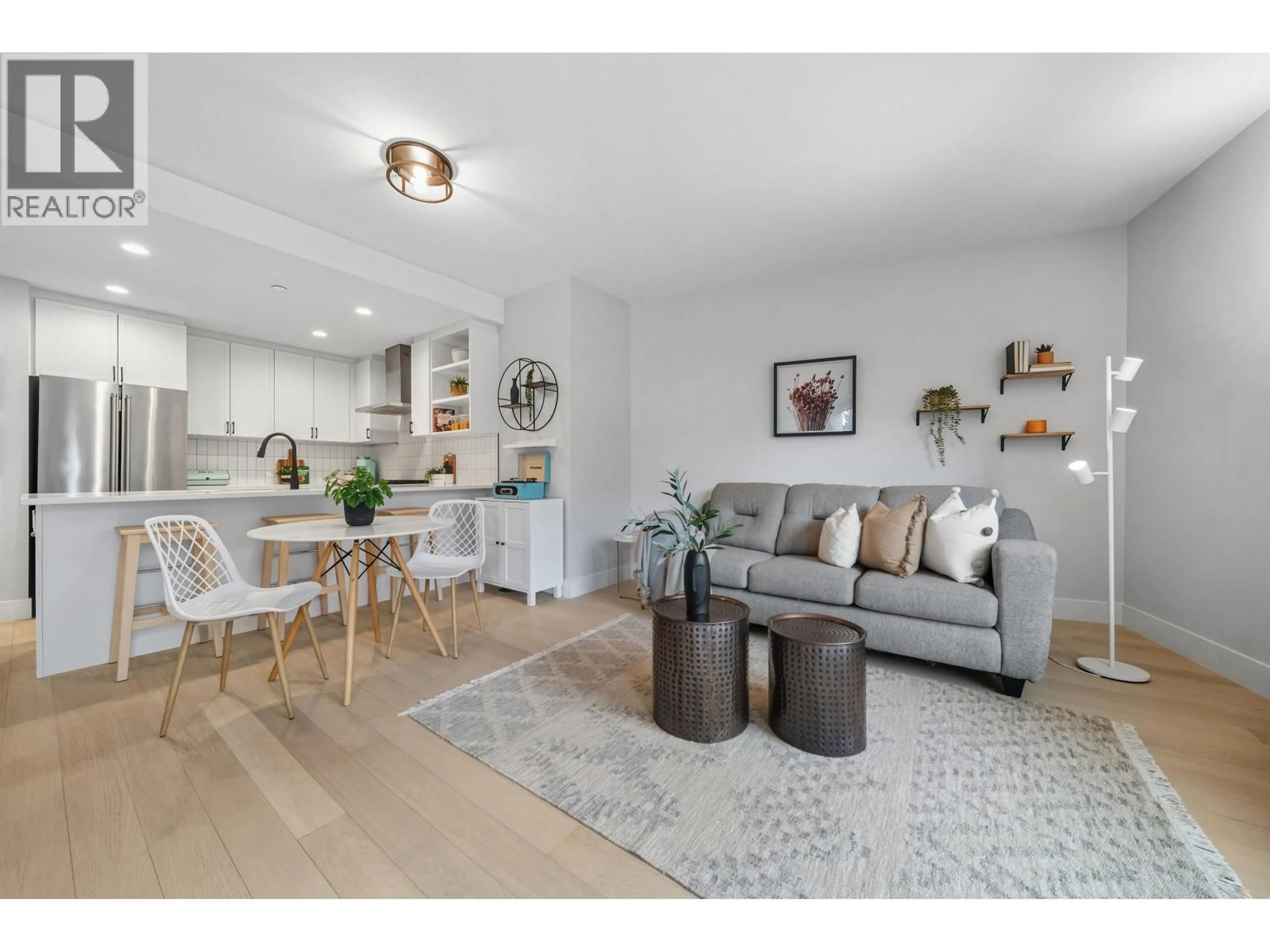 Living room with furniture, wood/laminate floor for 201 - 22226 BROWN AVENUE, Maple Ridge British Columbia V2X4R2