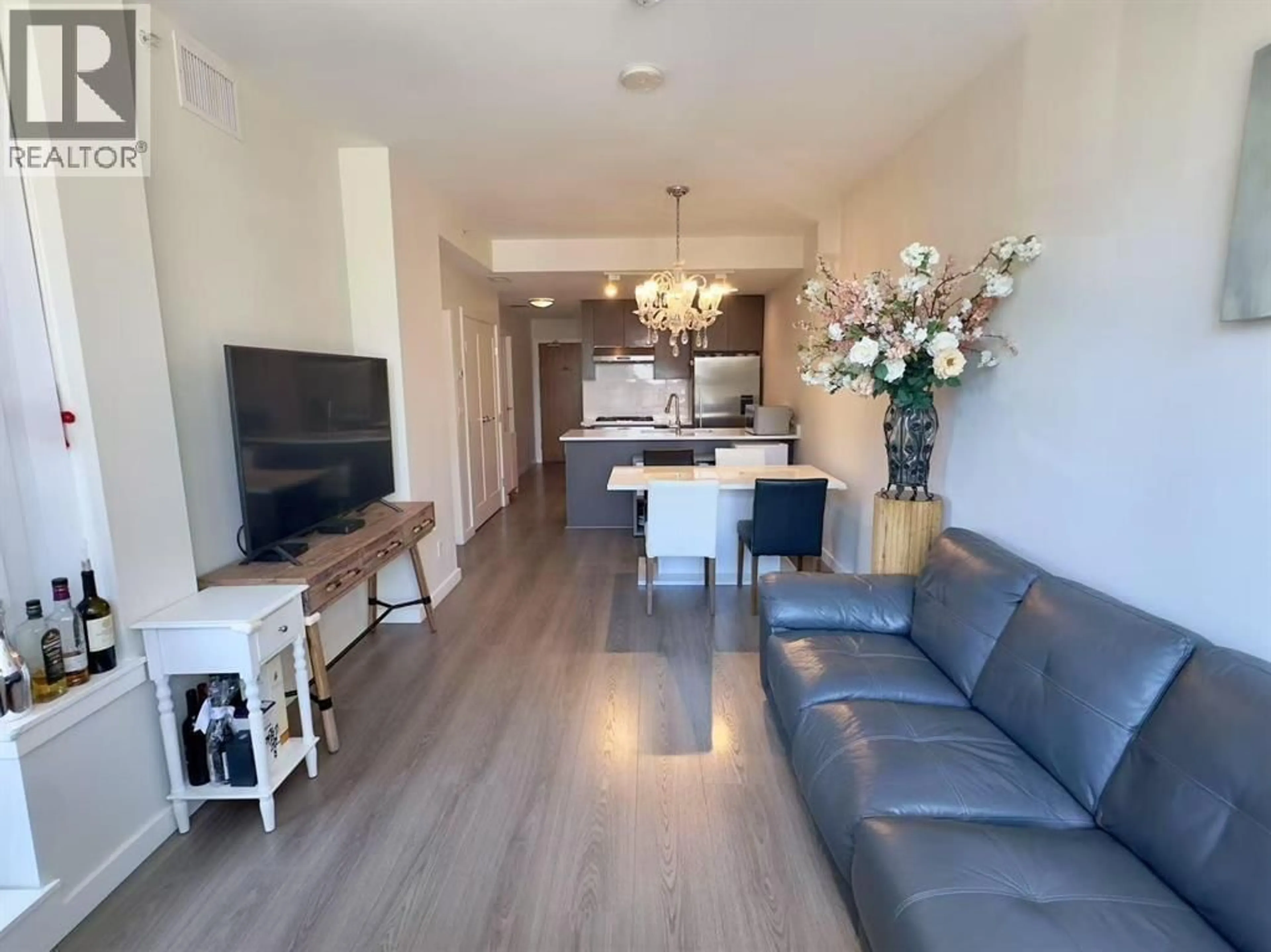 Living room with furniture, wood/laminate floor for 309 - 3333 SEXSMITH ROAD, Richmond British Columbia V6X0R7