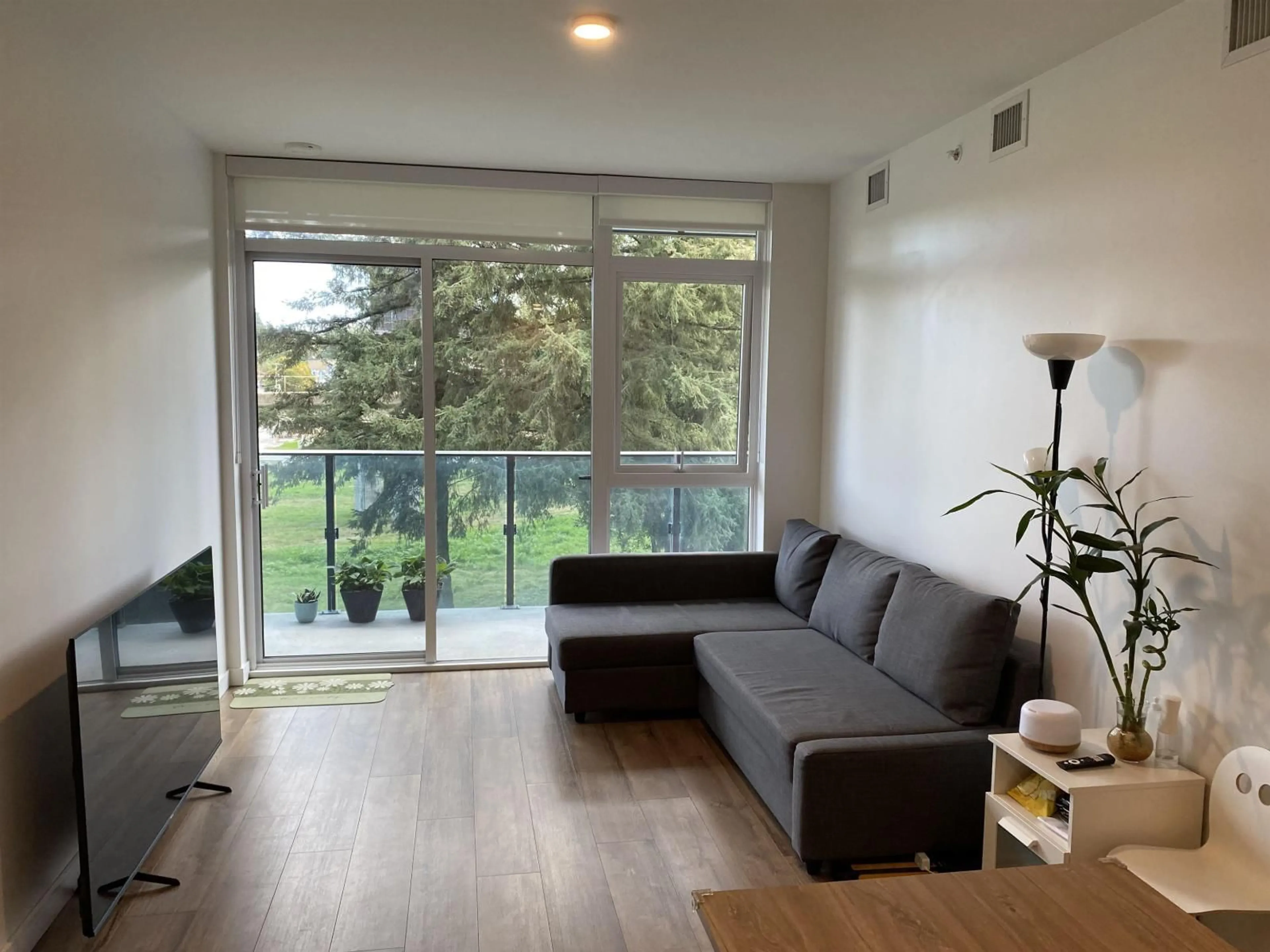 Living room with furniture, wood/laminate floor for 307 - 13428 105, Surrey British Columbia V3T0S6