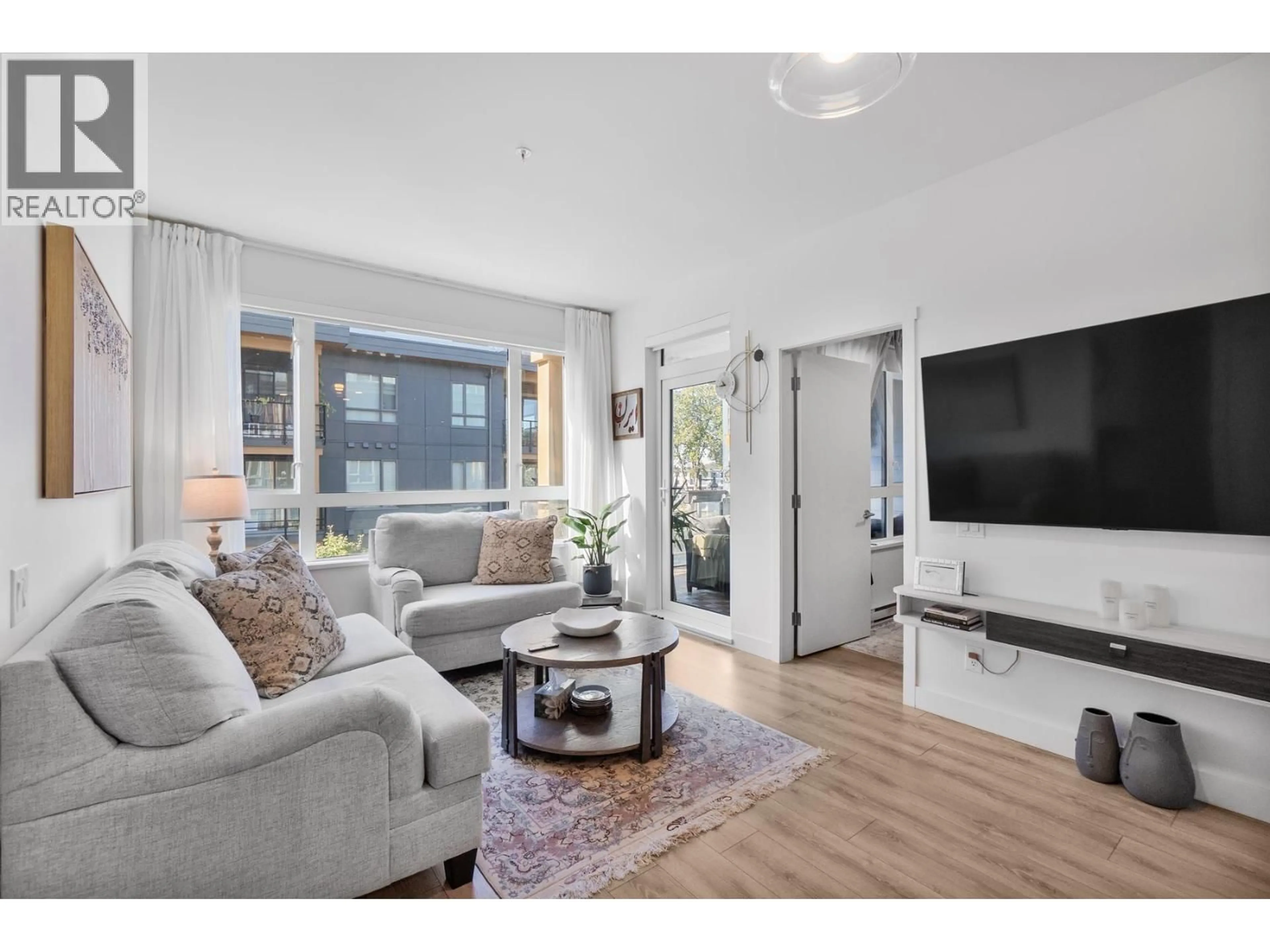 Living room with furniture, wood/laminate floor for 310 - 735 ANSKAR COURT, Coquitlam British Columbia V3J0L7