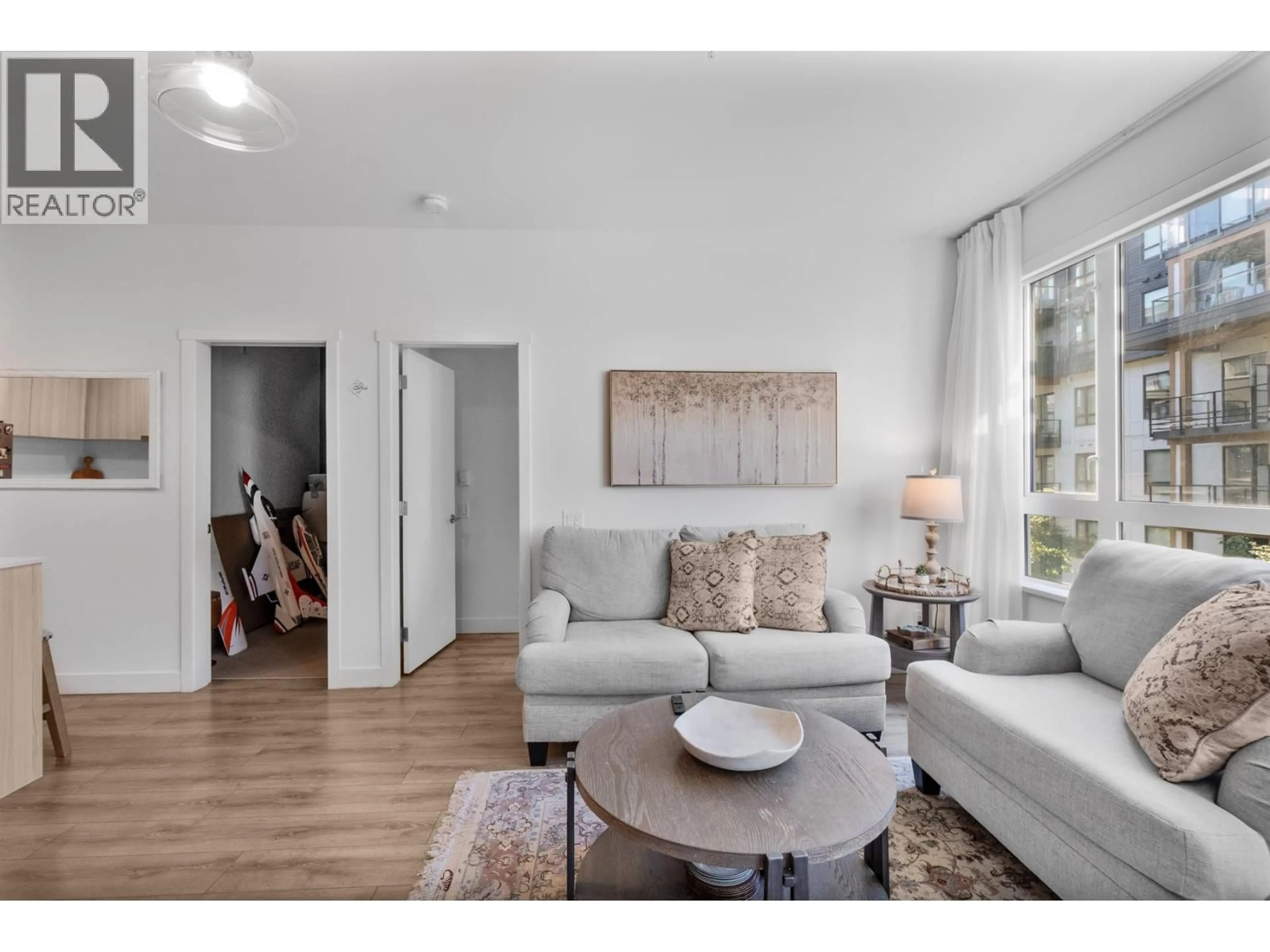 Living room with furniture, wood/laminate floor for 310 - 735 ANSKAR COURT, Coquitlam British Columbia V3J0L7