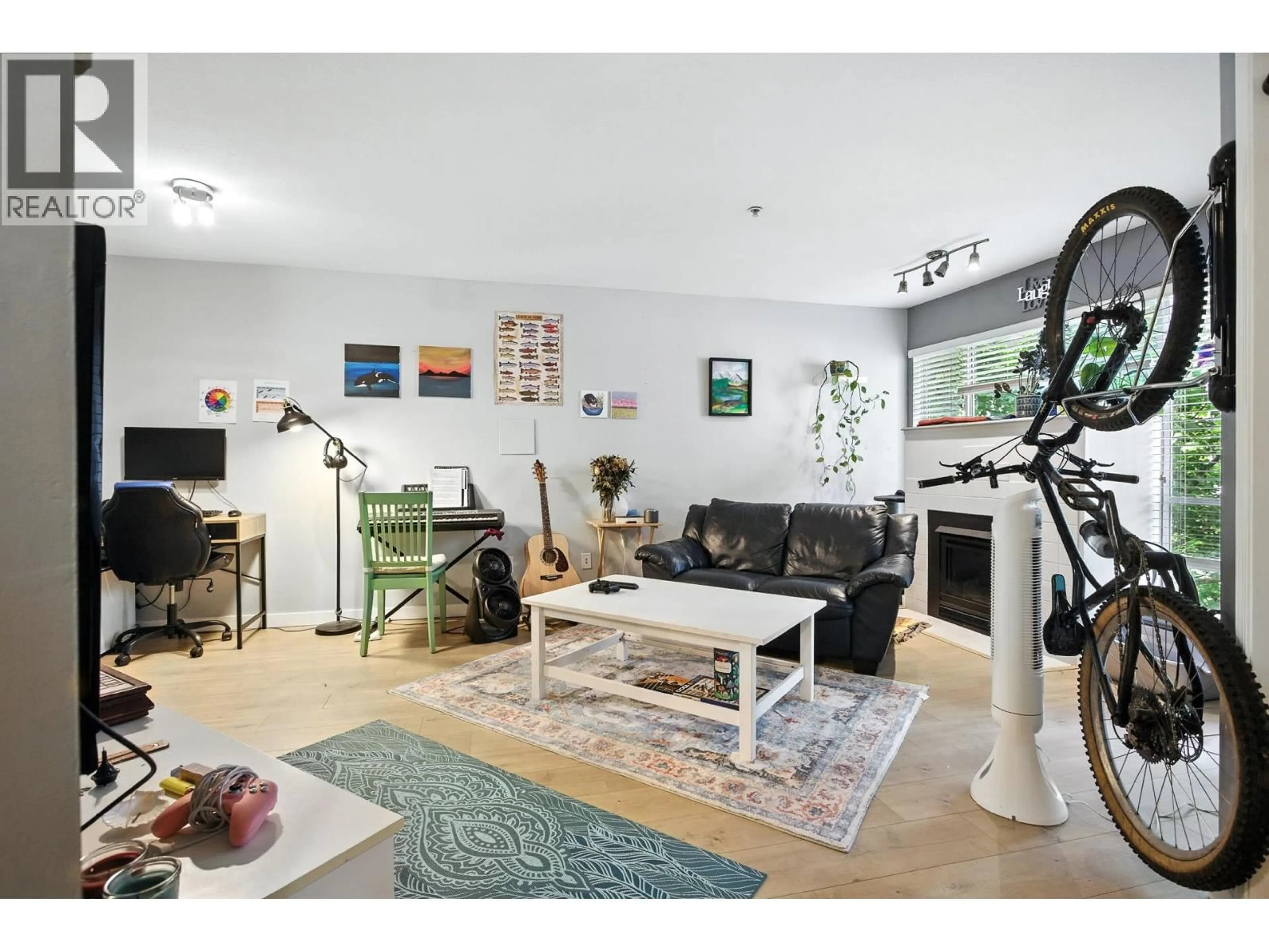 Living room with furniture, wood/laminate floor for 209 - 2401 HAWTHORNE AVENUE, Port Coquitlam British Columbia V3C6E9