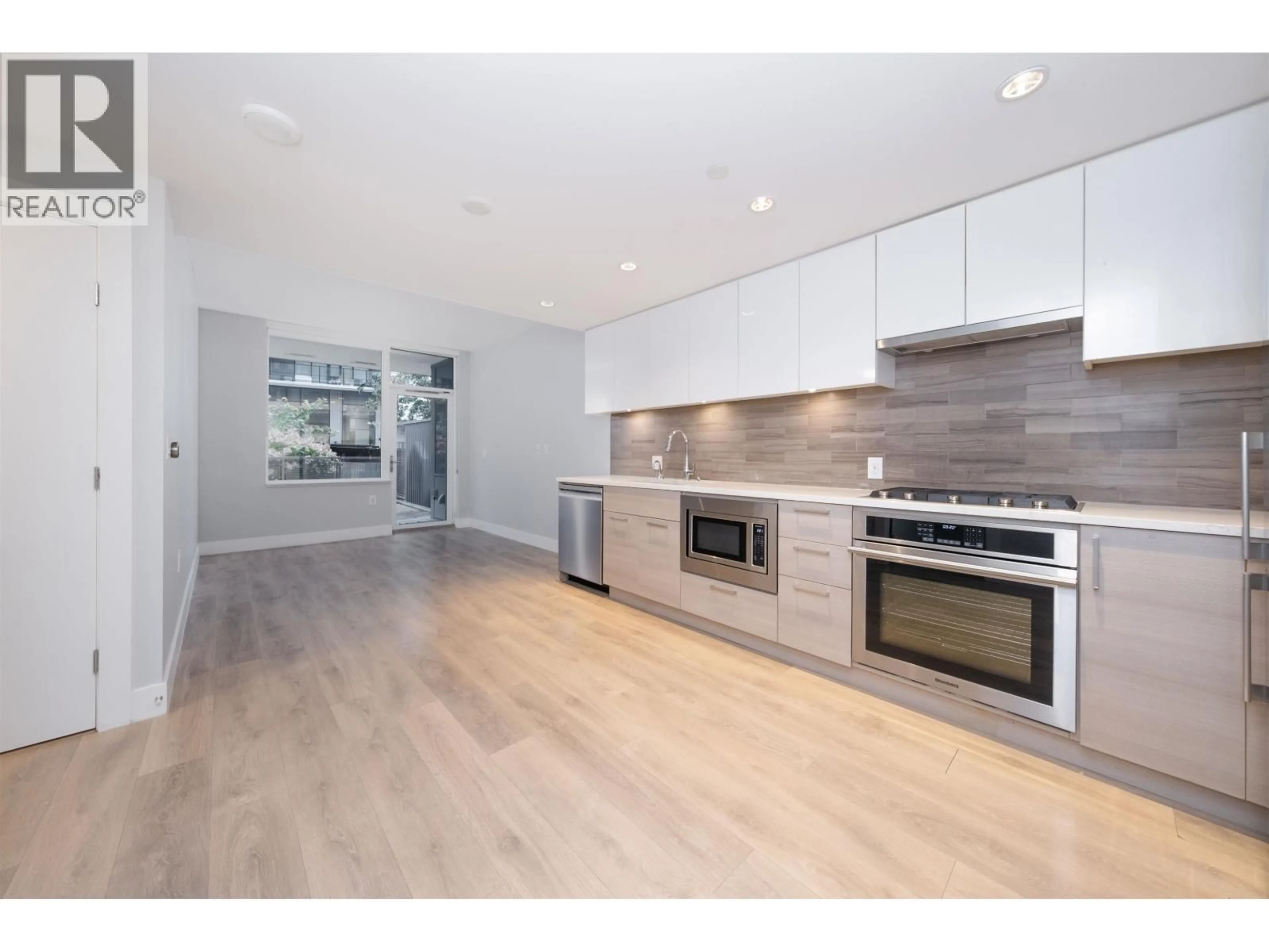 Open concept kitchen, wood/laminate floor for 201 - 3451 SAWMILL CRESCENT, Vancouver British Columbia V5S0H3