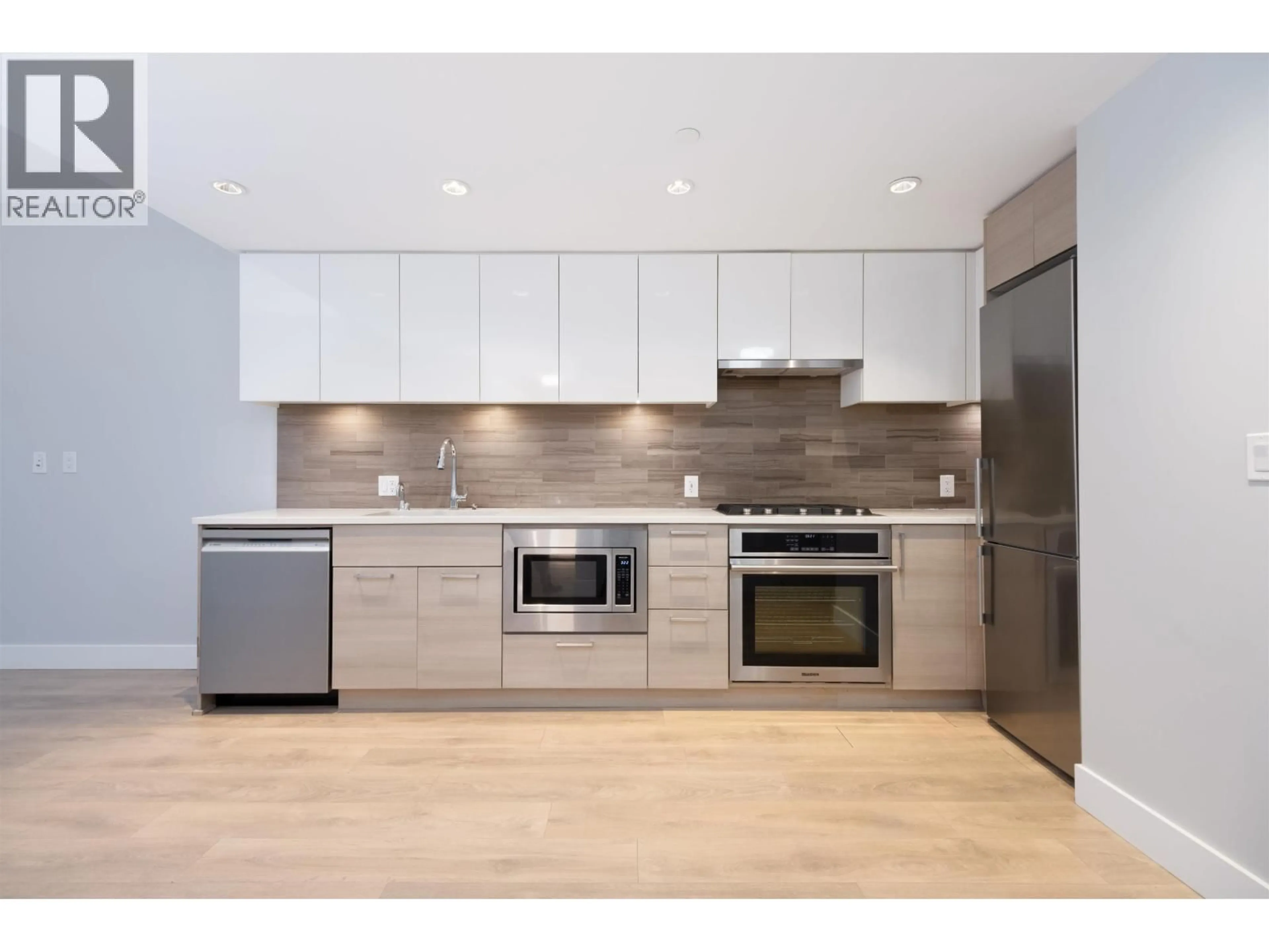Open concept kitchen, wood/laminate floor for 201 - 3451 SAWMILL CRESCENT, Vancouver British Columbia V5S0H3