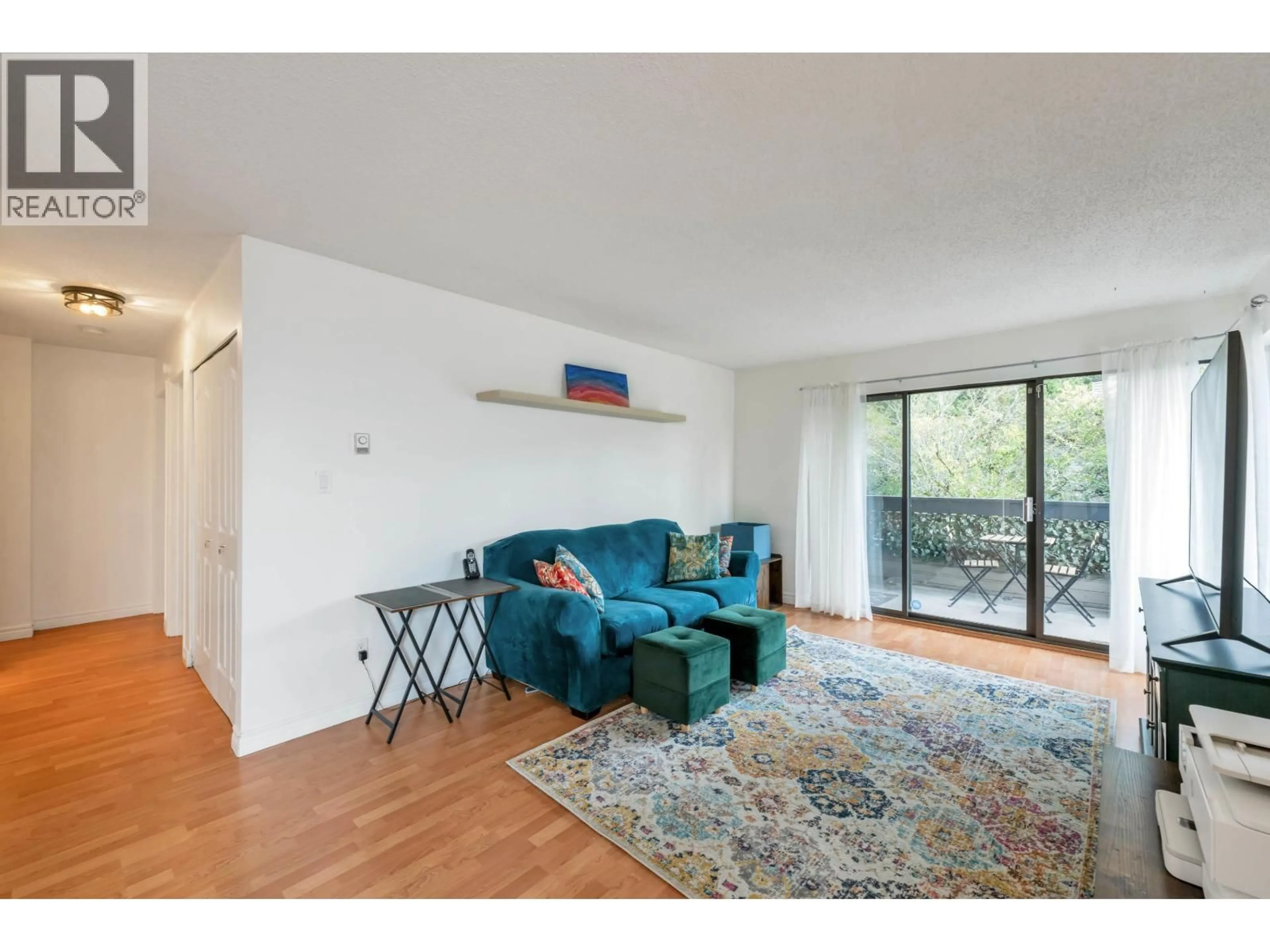 Living room with furniture, wood/laminate floor for 204 - 1195 PIPELINE ROAD, Coquitlam British Columbia V3B6J5