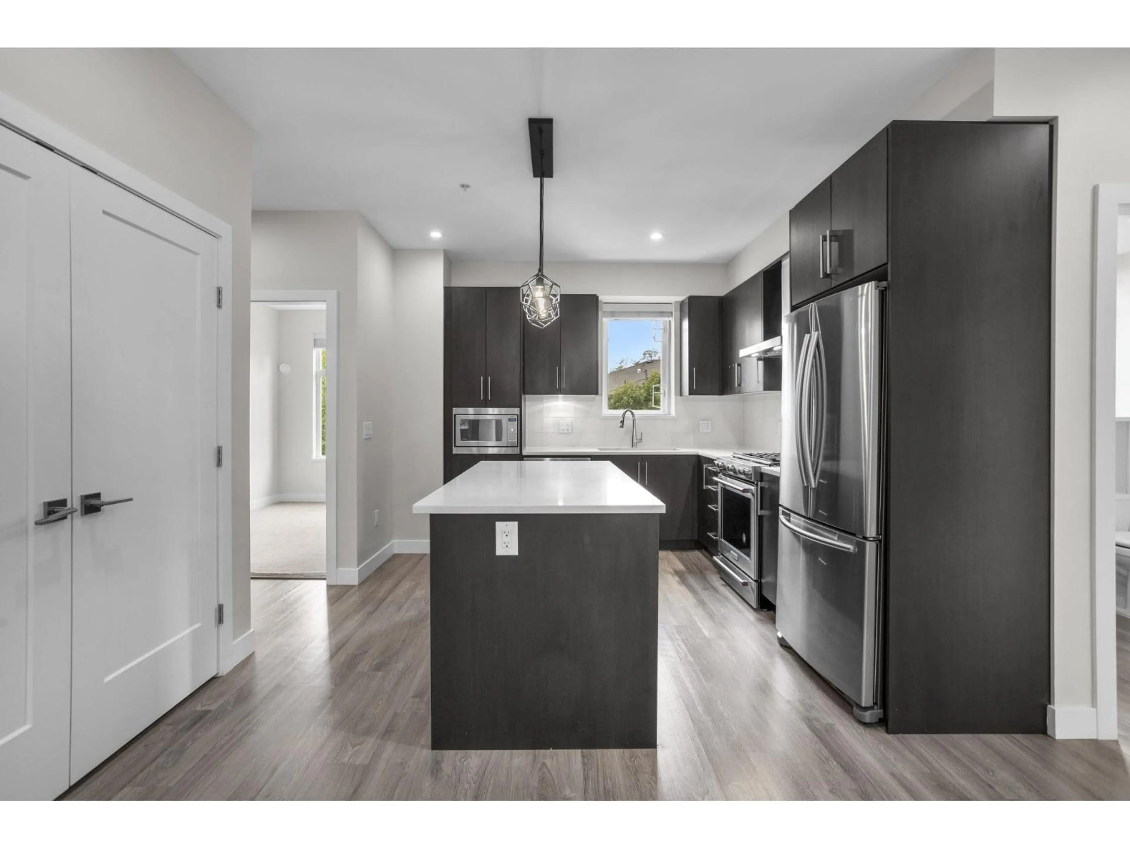 Open concept kitchen, wood/laminate floor for 306 - 15436 31, Surrey British Columbia V3Z1H3