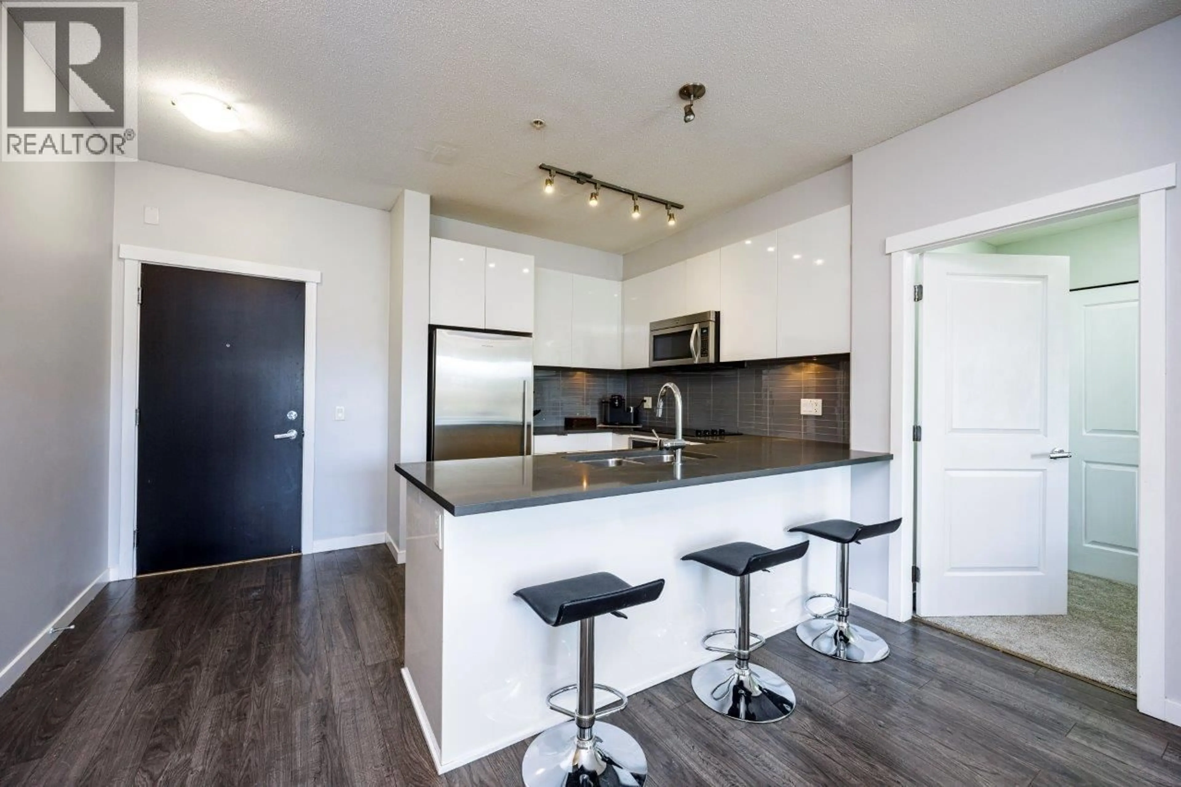 Open concept kitchen, wood/laminate floor for 301 - 2665 MOUNTAIN HIGHWAY, North Vancouver British Columbia V7J0A8