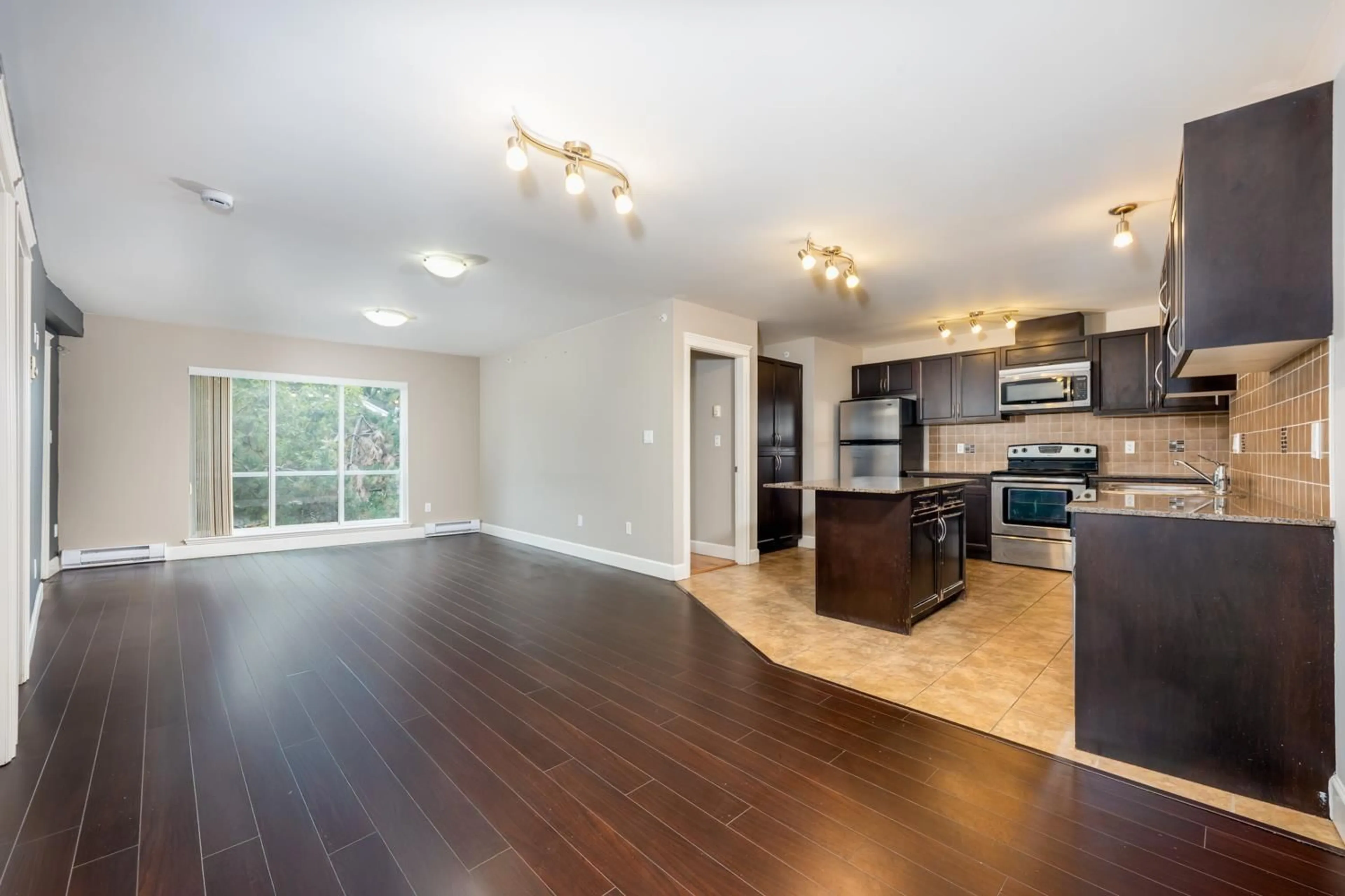 Open concept kitchen, wood/laminate floor for 311 - 12088 75A, Surrey British Columbia V3W1Y4