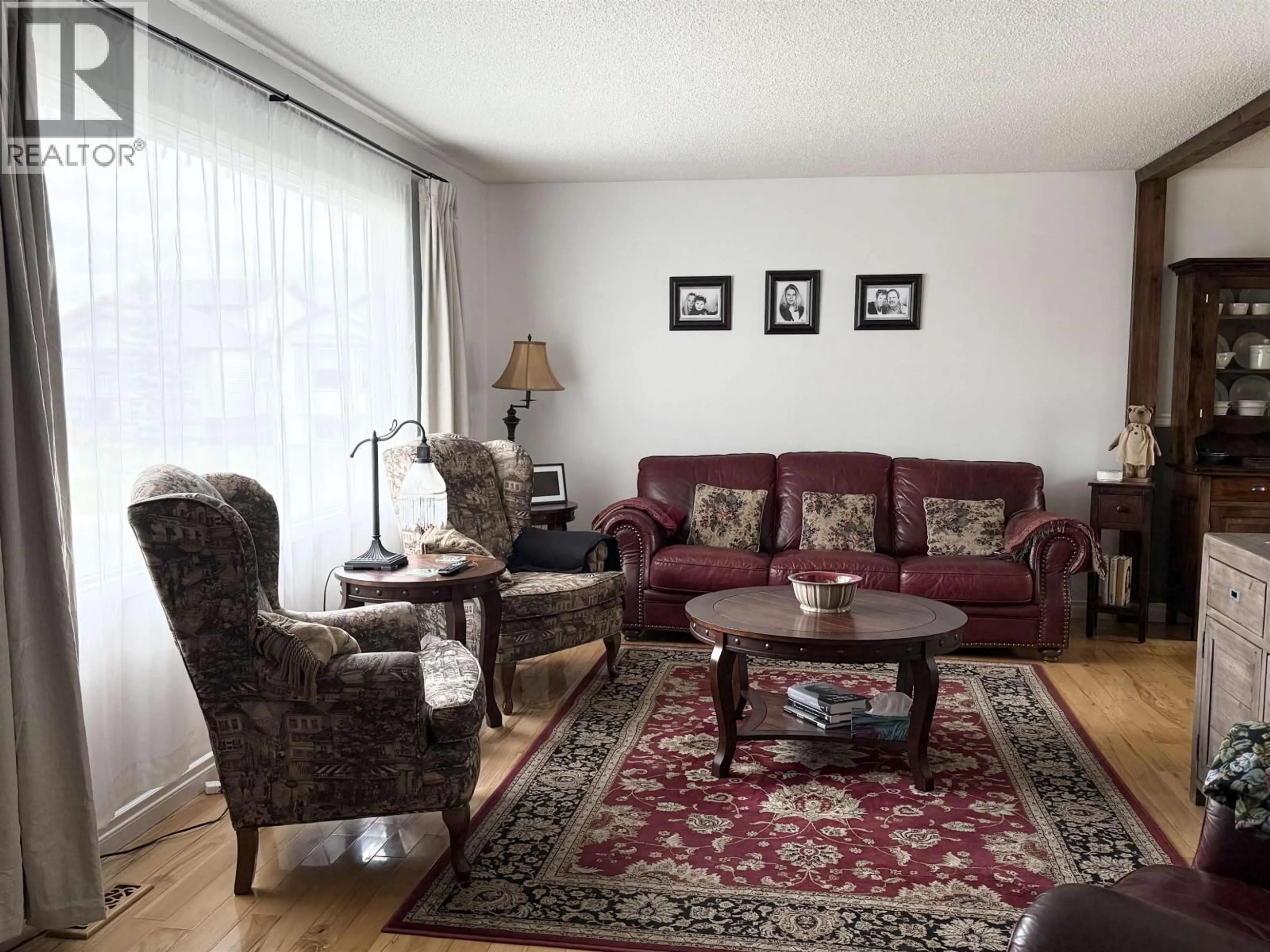 Living room with furniture, wood/laminate floor for 9803 113 AVENUE, Fort St. John British Columbia V1J4P7