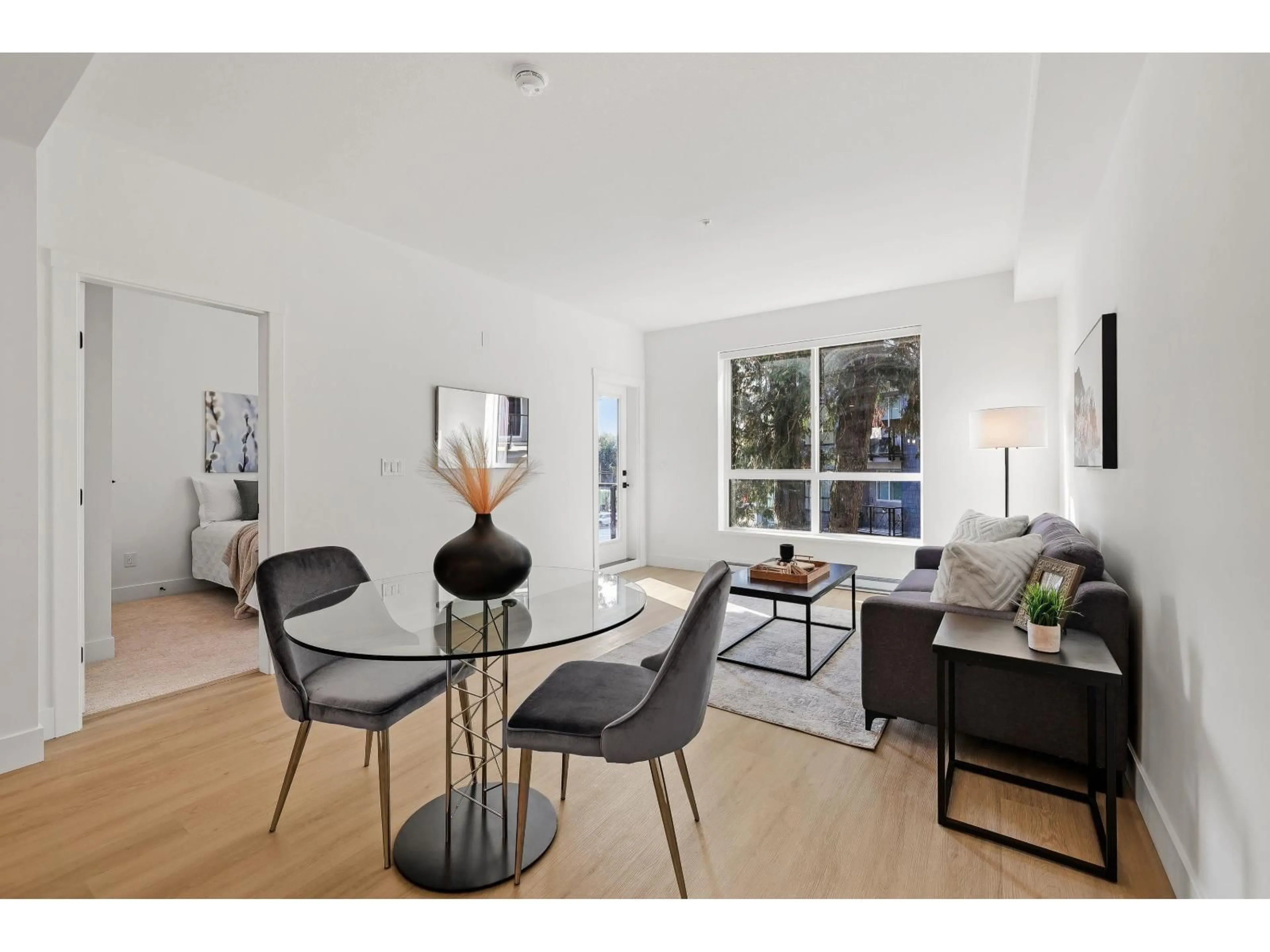 Living room with furniture, wood/laminate floor for 309 - 3438 146A, Surrey British Columbia V0V0V0