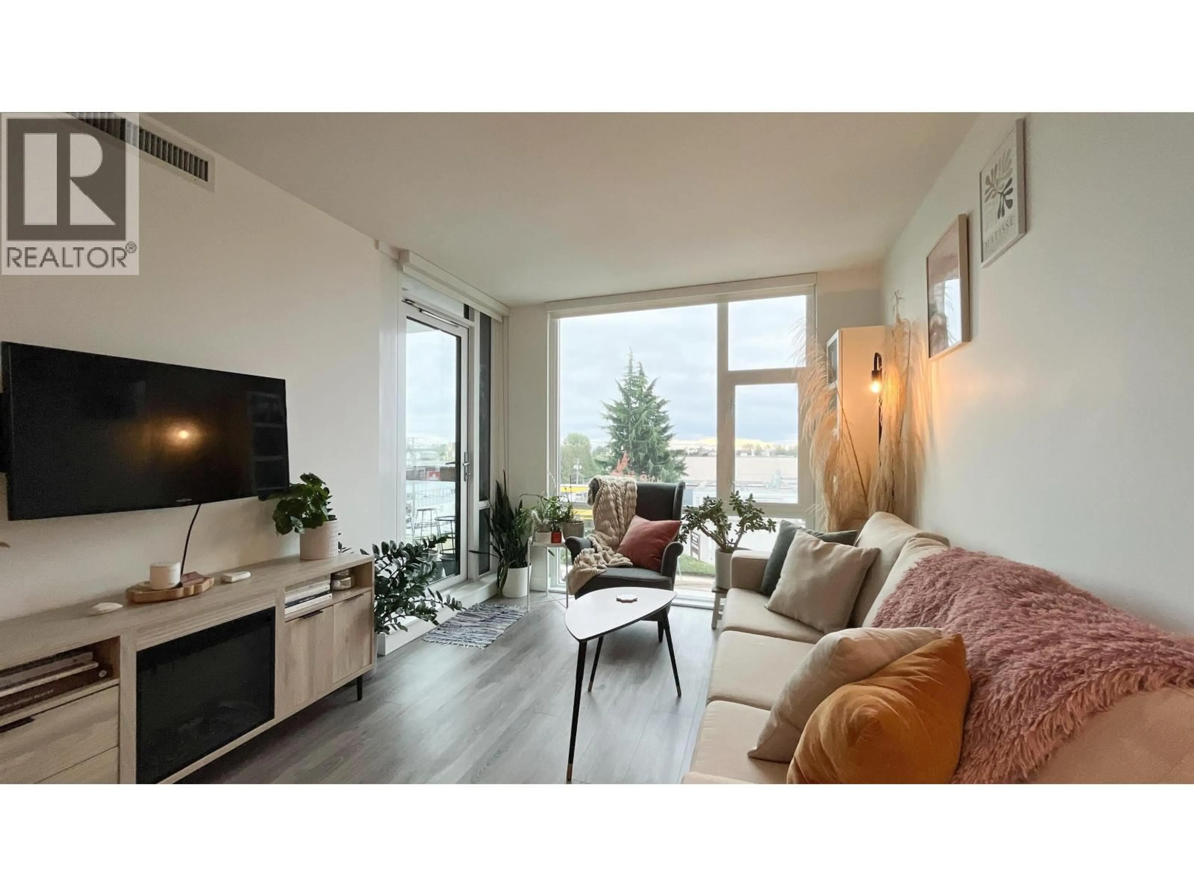 Living room with furniture, wood/laminate floor for 210 - 8181 CHESTER STREET, Vancouver British Columbia V5X0J9