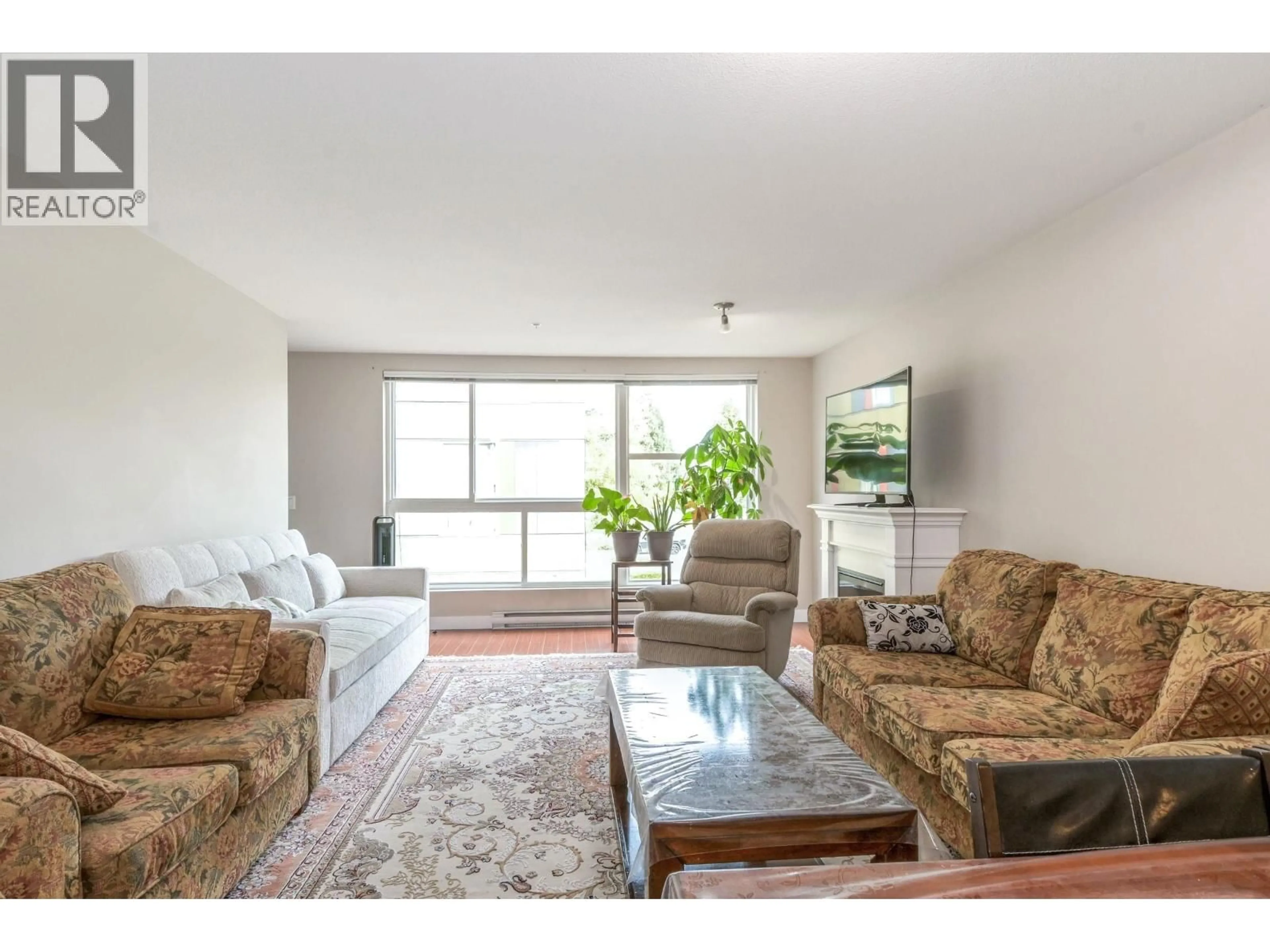 Living room with furniture, wood/laminate floor for 228 - 12085 228 STREET, Maple Ridge British Columbia V2X6M2