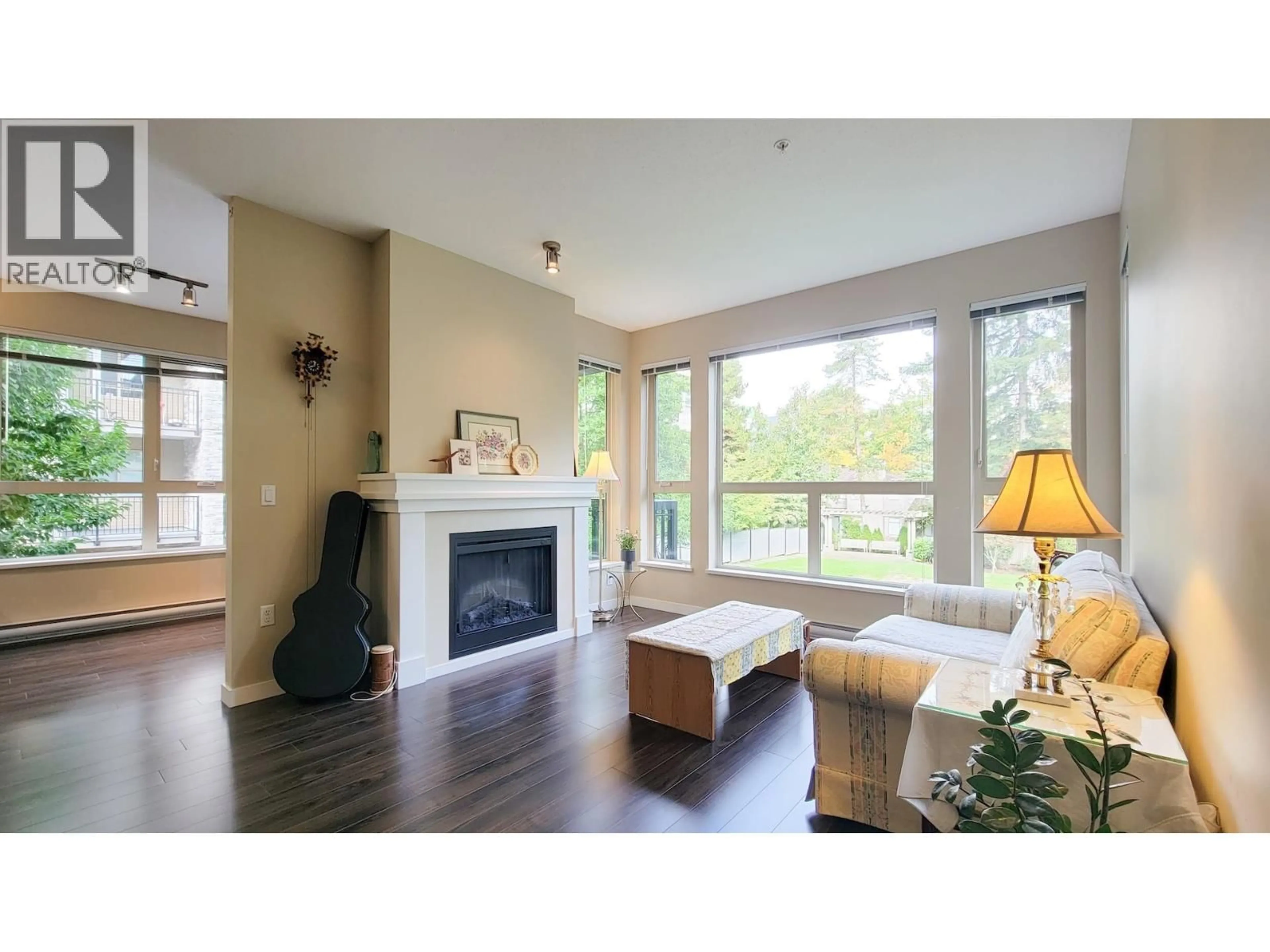Living room with furniture, wood/laminate floor for 204 - 1150 KENSAL PLACE, Coquitlam British Columbia V3B0H4