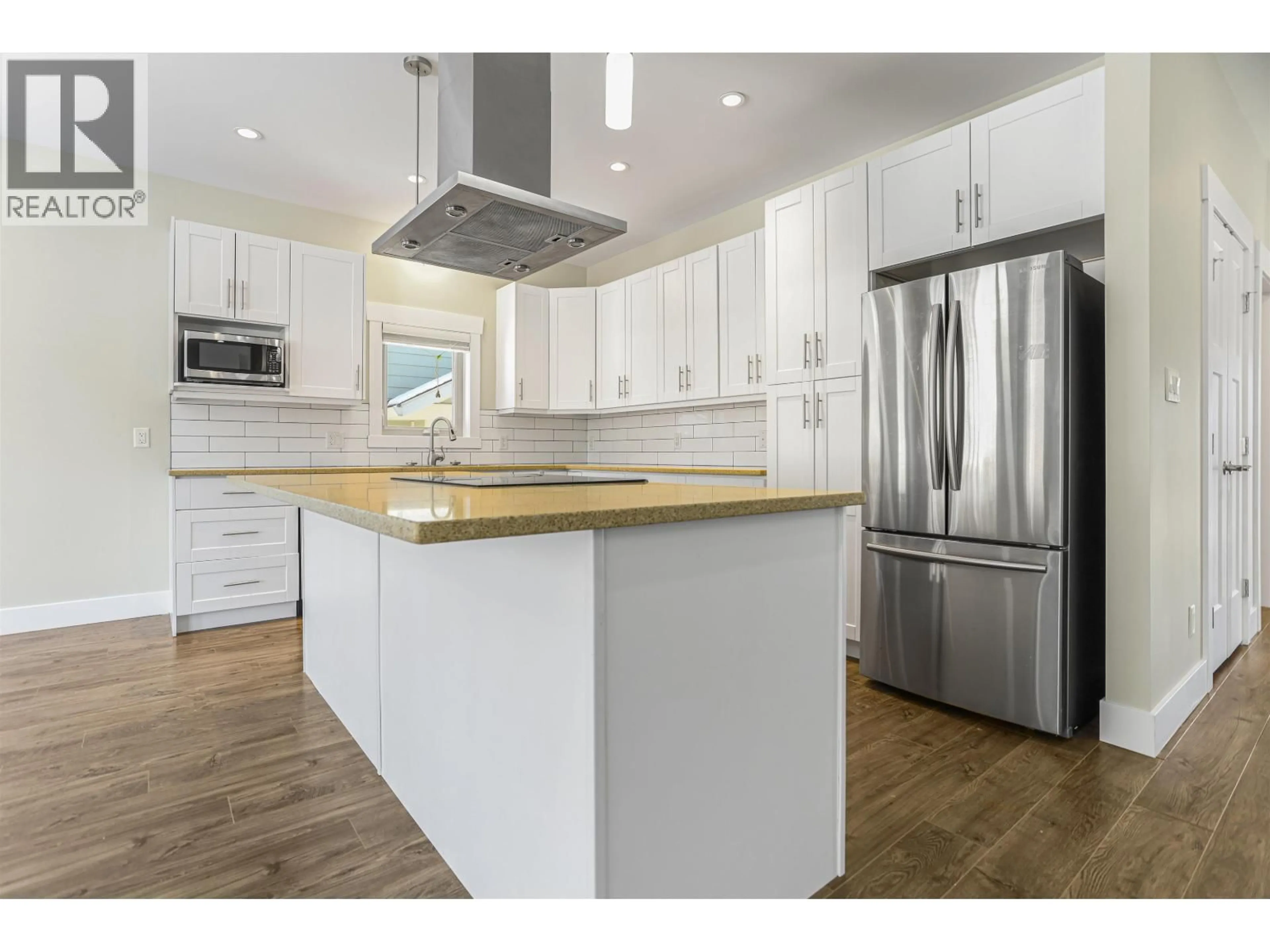 Open concept kitchen, wood/laminate floor for 52 BLACKBERRY STREET, Kitimat British Columbia V8C0A6