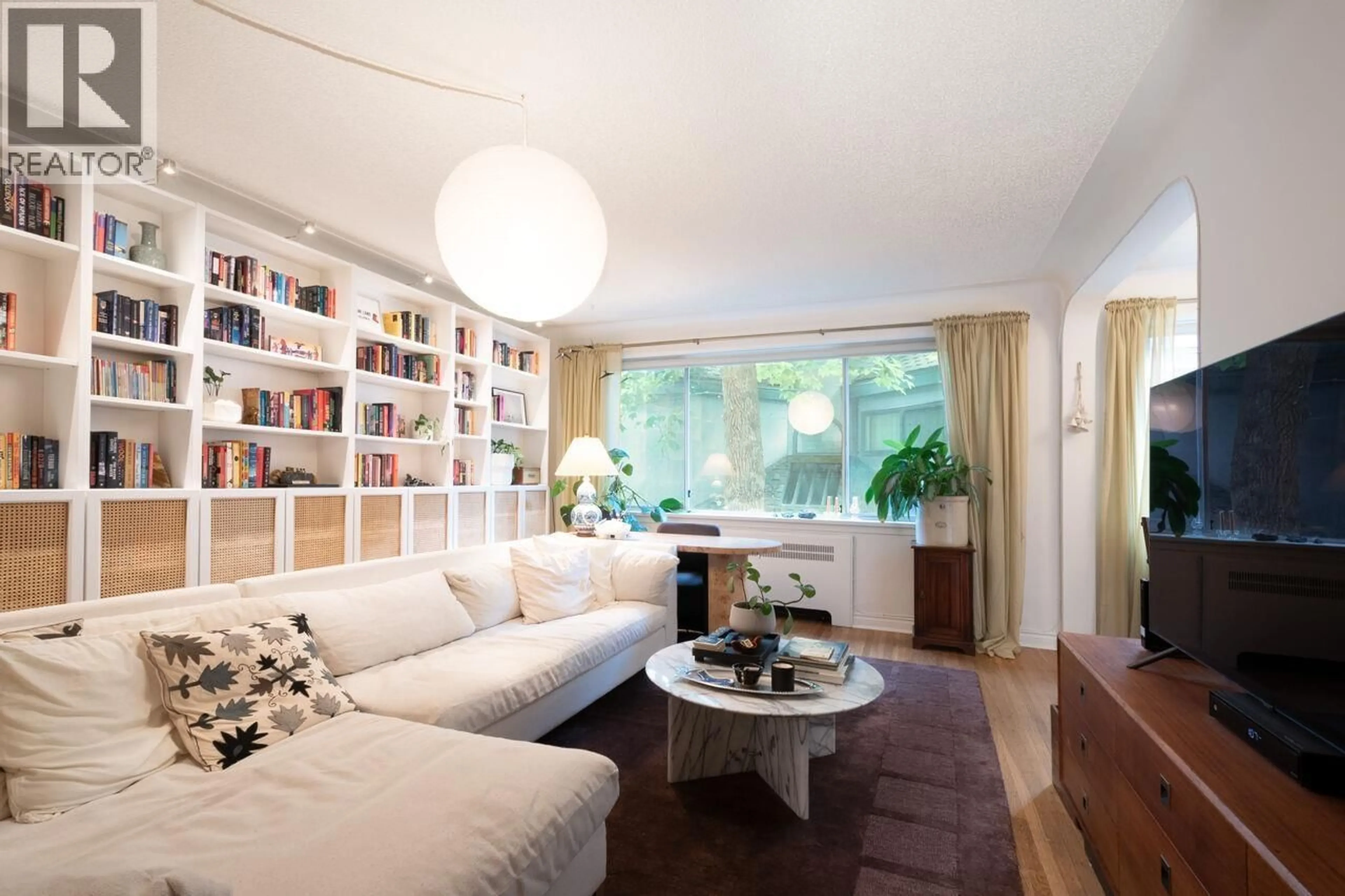 Living room with furniture, wood/laminate floor for 103 - 985 JERVIS STREET, Vancouver British Columbia V6E2B7