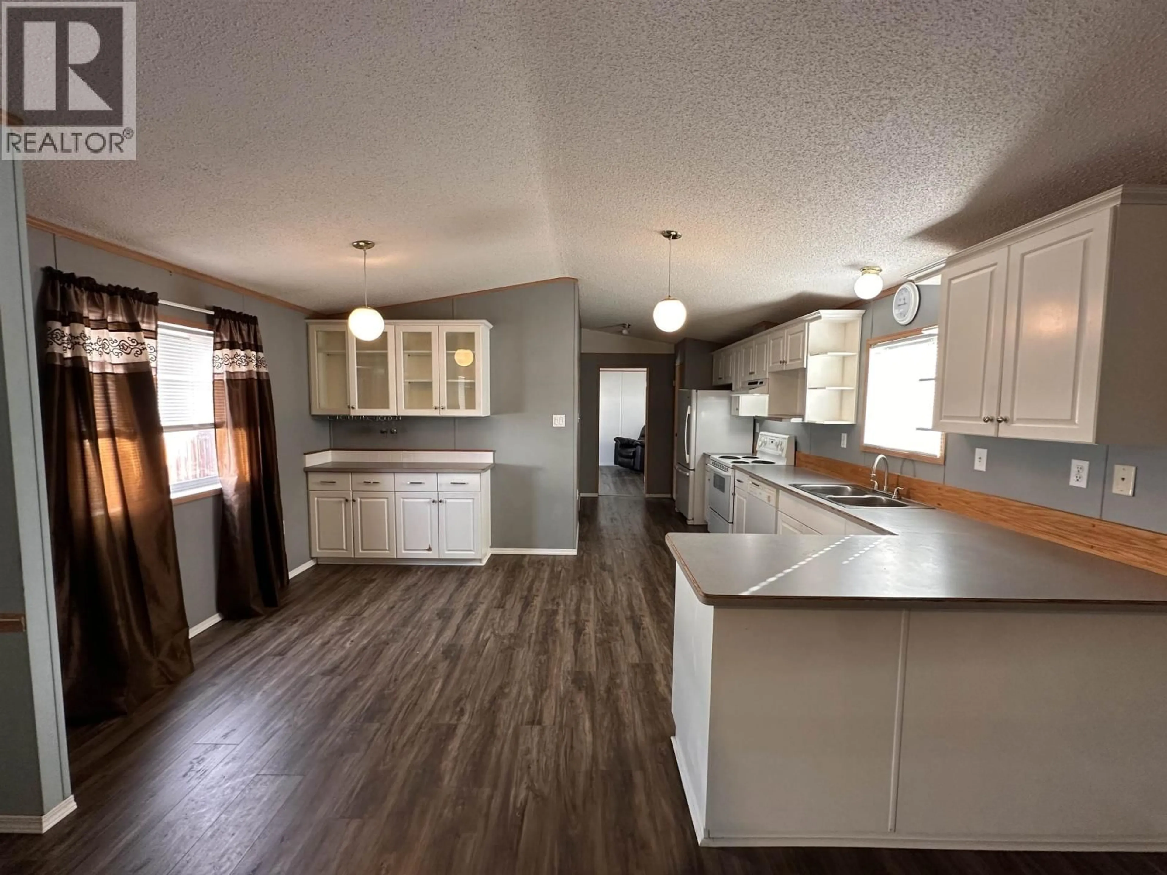 Open concept kitchen, wood/laminate floor for 5508 42 STREET, Fort Nelson British Columbia V0C1R0