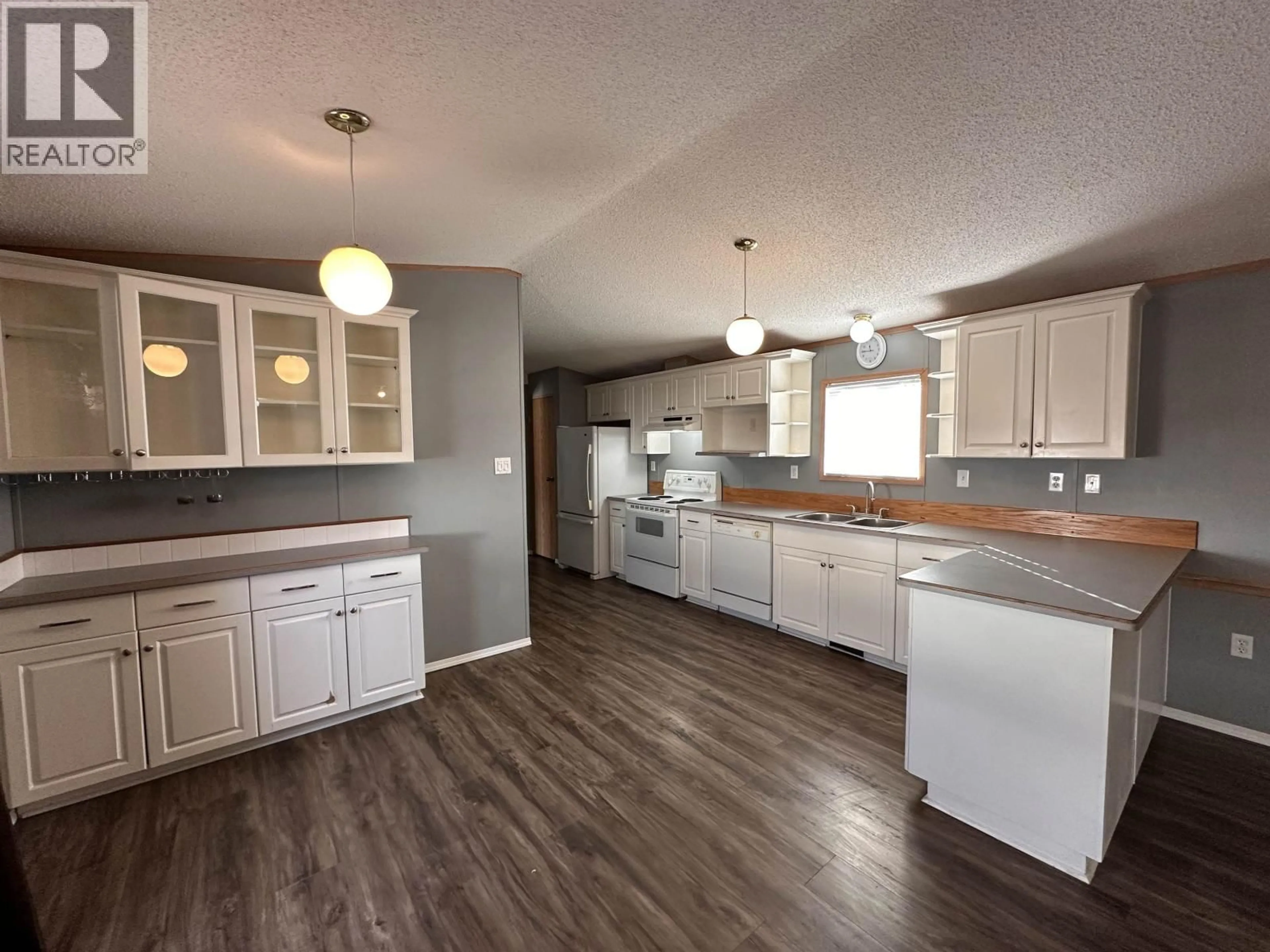 Open concept kitchen, wood/laminate floor for 5508 42 STREET, Fort Nelson British Columbia V0C1R0