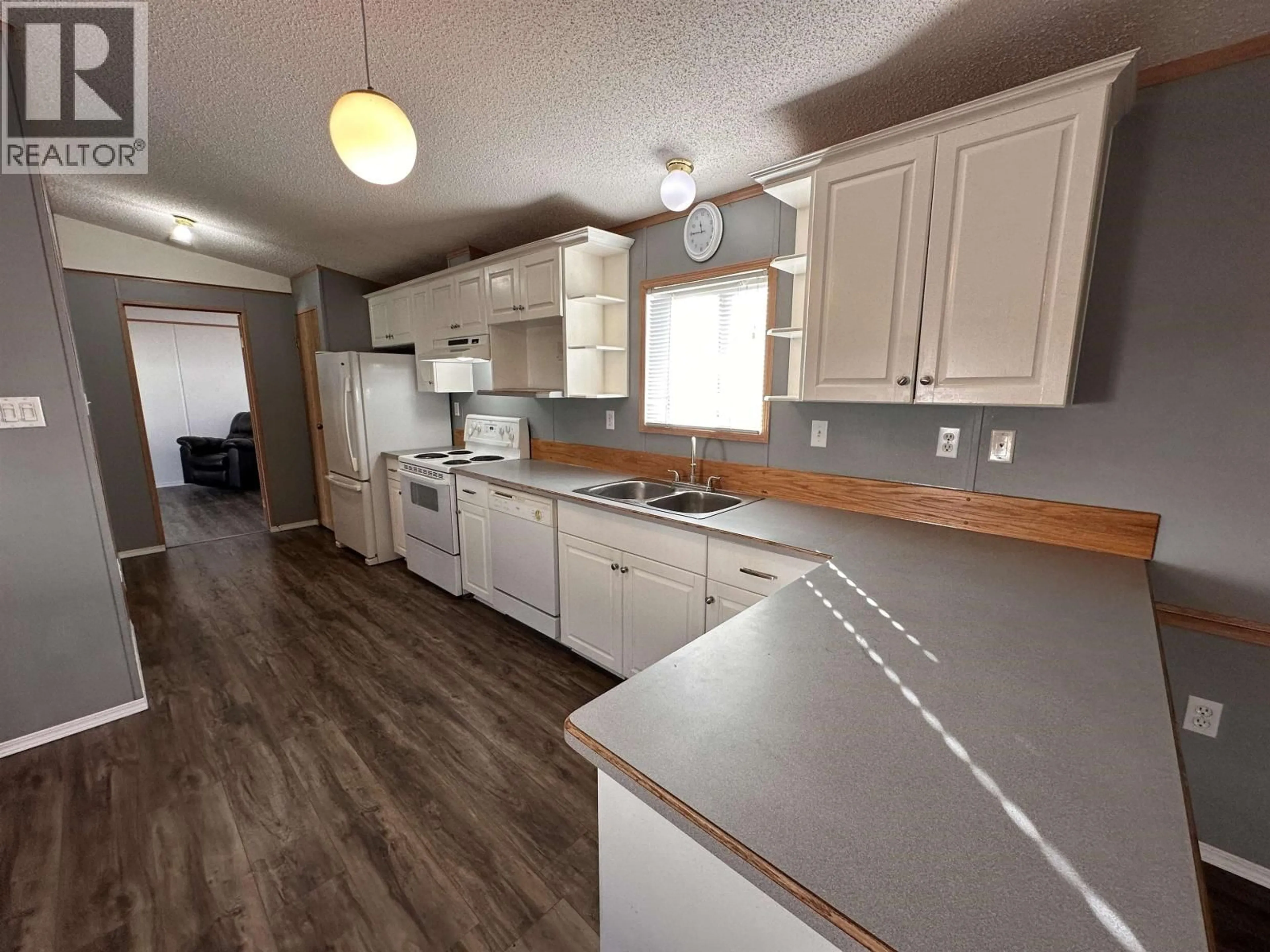 Open concept kitchen, wood/laminate floor for 5508 42 STREET, Fort Nelson British Columbia V0C1R0