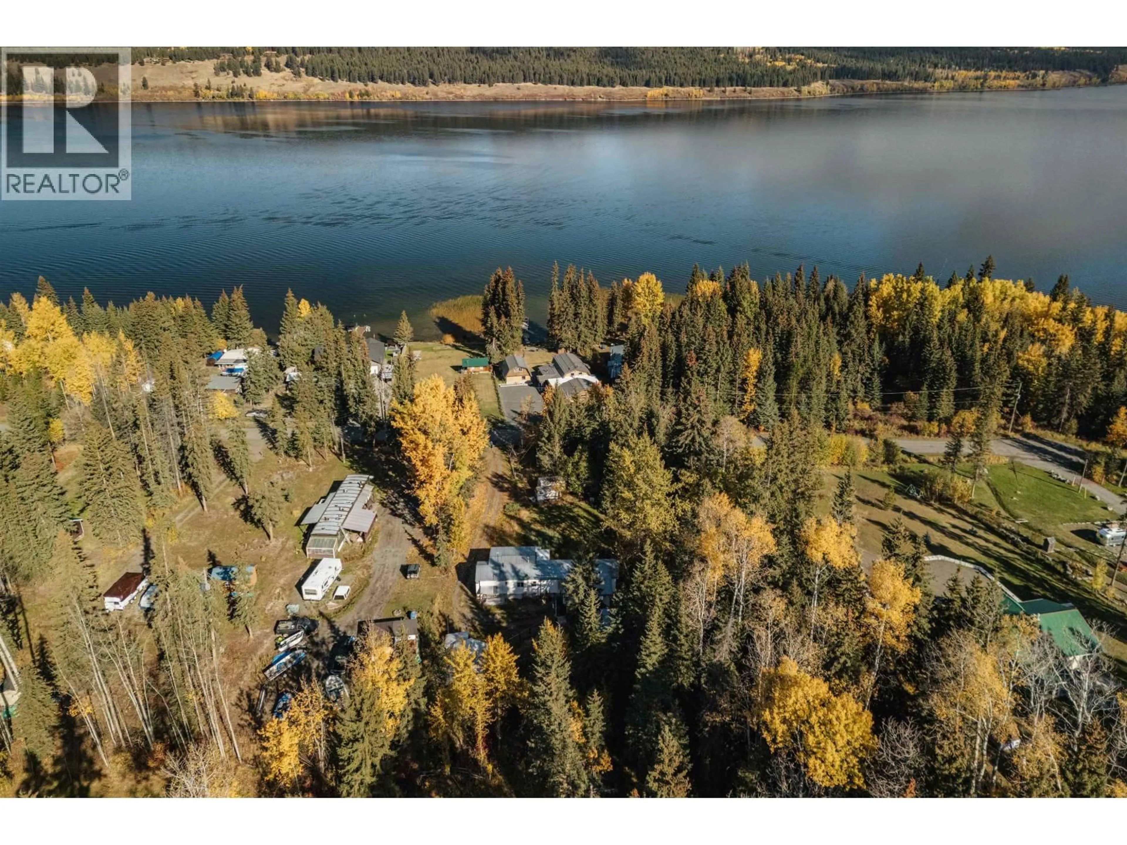 A pic from outside/outdoor area/front of a property/back of a property/a pic from drone, water/lake/river/ocean view for 6388 MULLIGAN DRIVE, 100 Mile House British Columbia V0K2E3