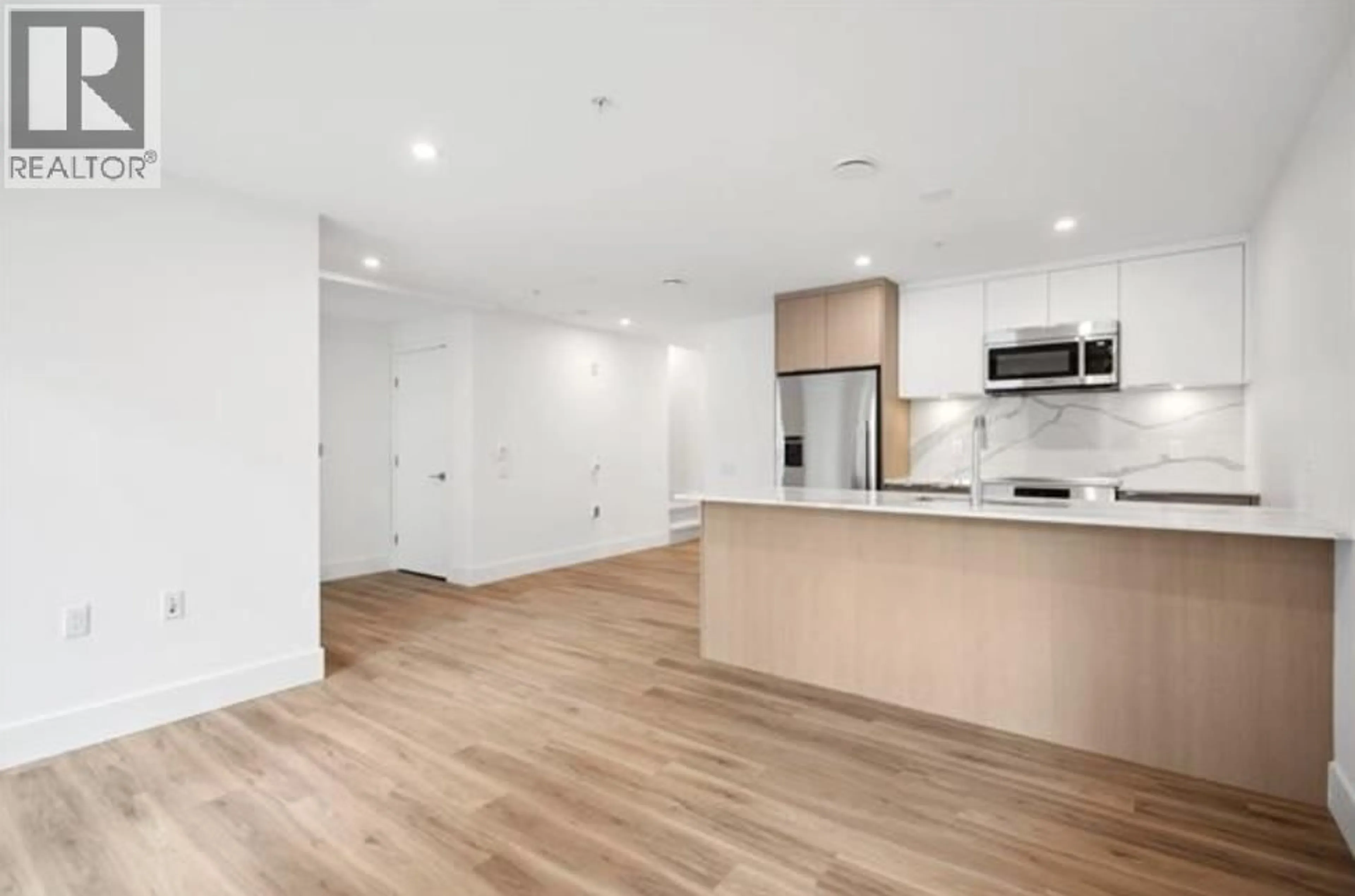 Open concept kitchen, wood/laminate floor for 110 - 2085 1ST AVENUE, Vancouver British Columbia V5N1B6