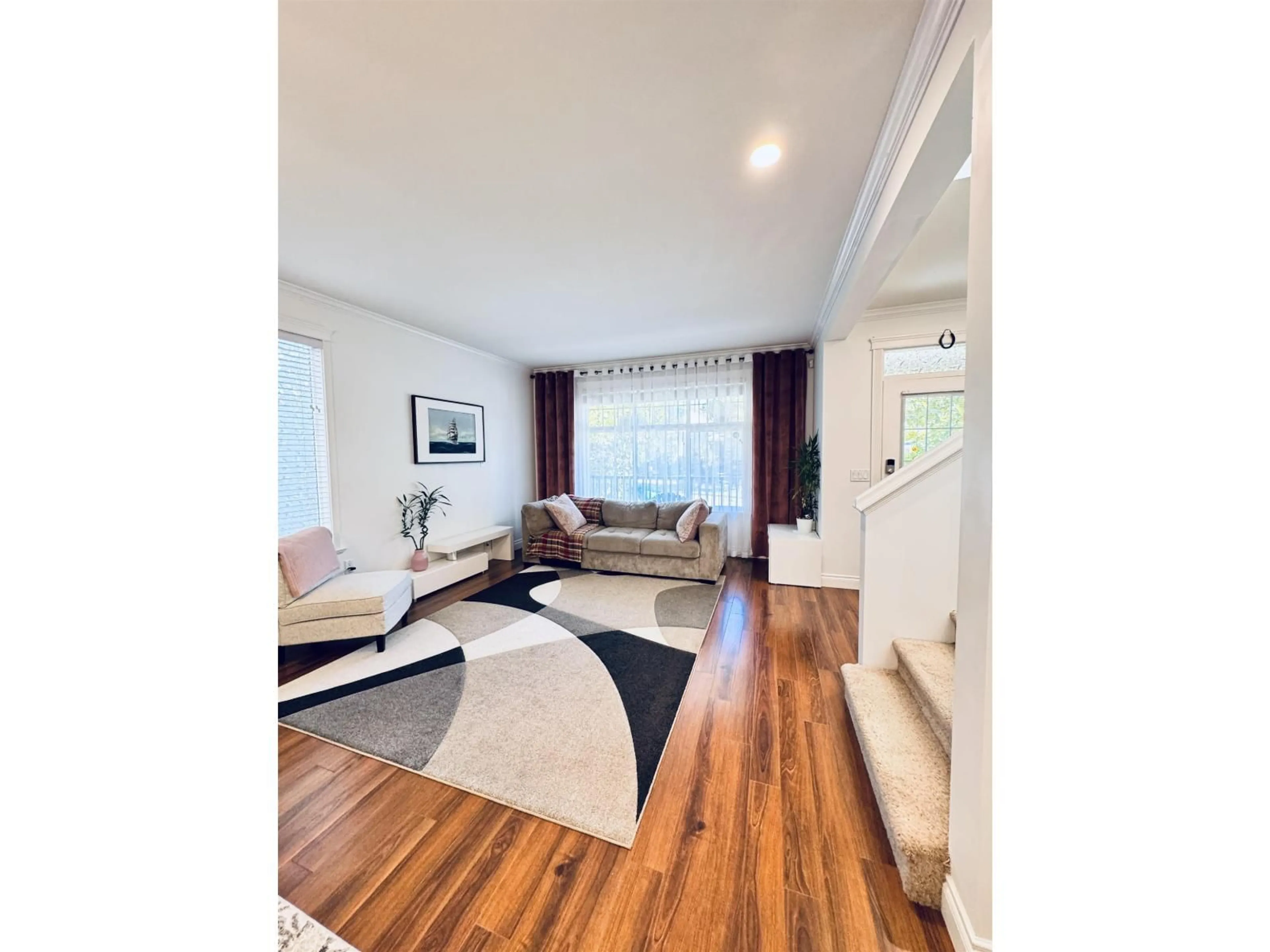 Living room with furniture, wood/laminate floor for 6631 192A, Surrey British Columbia V4N0B9