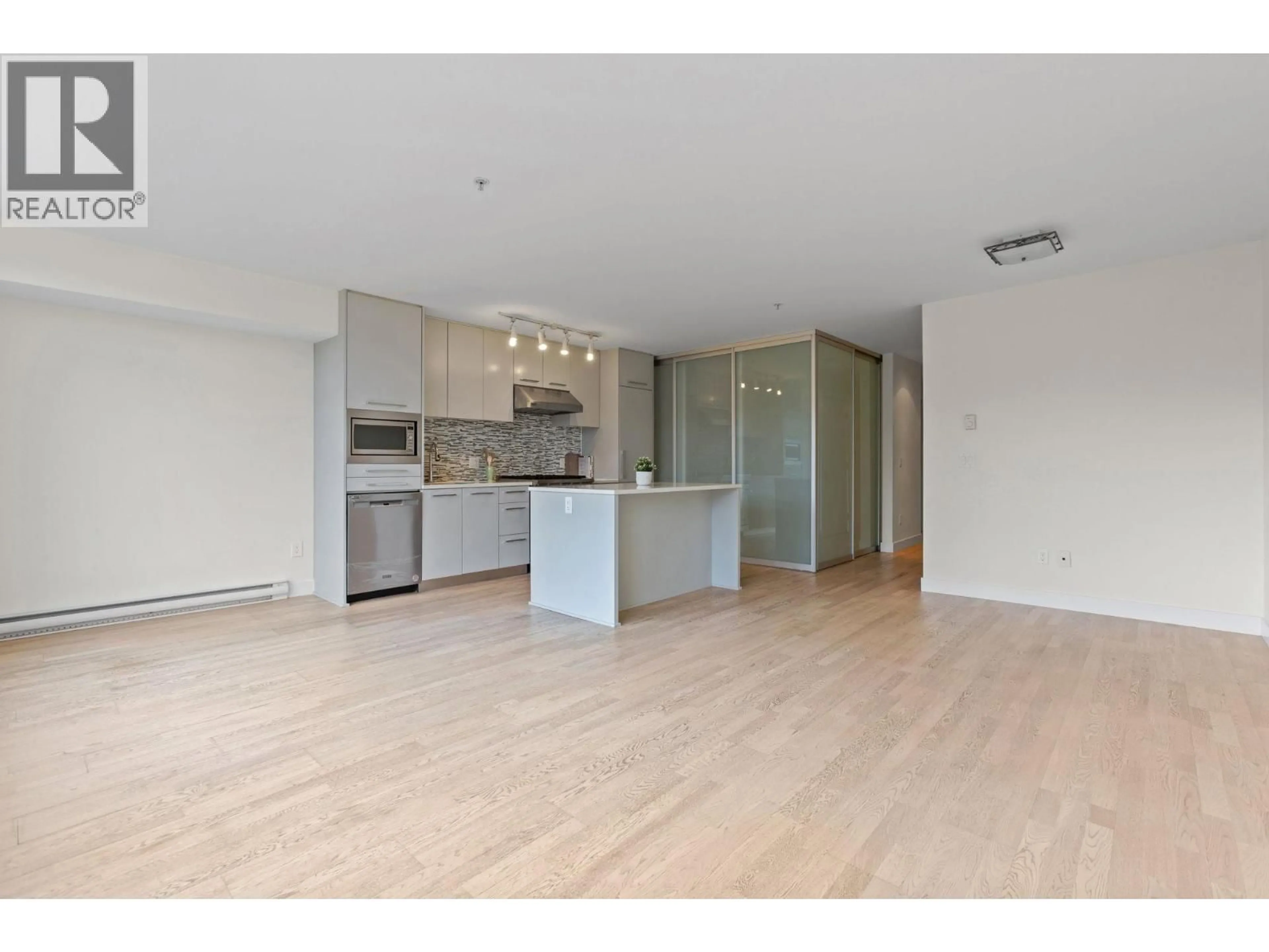 Open concept kitchen, wood/laminate floor for 306 - 4355 10TH AVENUE, Vancouver British Columbia V6R2H6