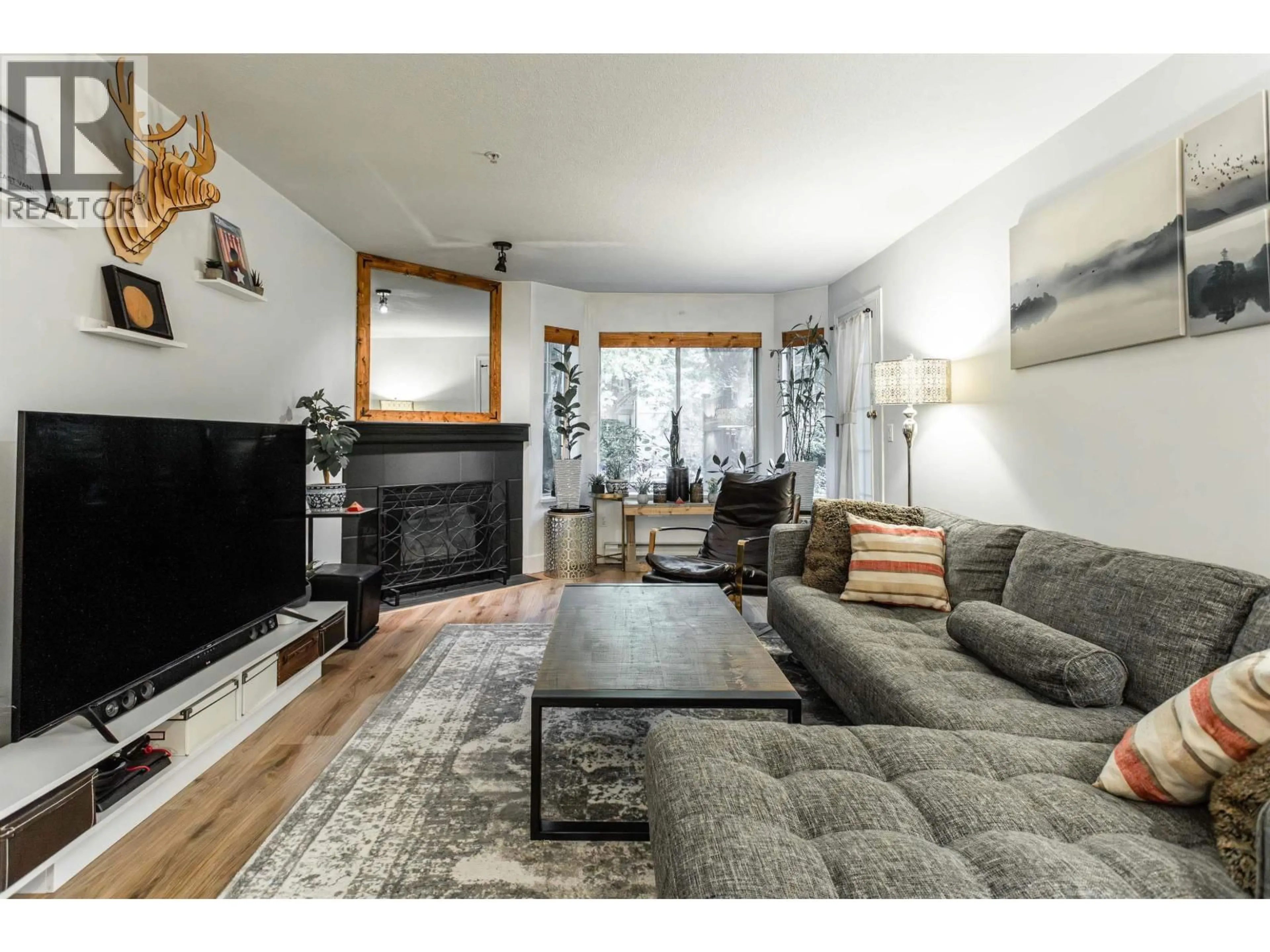 Living room with furniture, wood/laminate floor for 109 - 1215 PACIFIC STREET, Coquitlam British Columbia V3B7M4