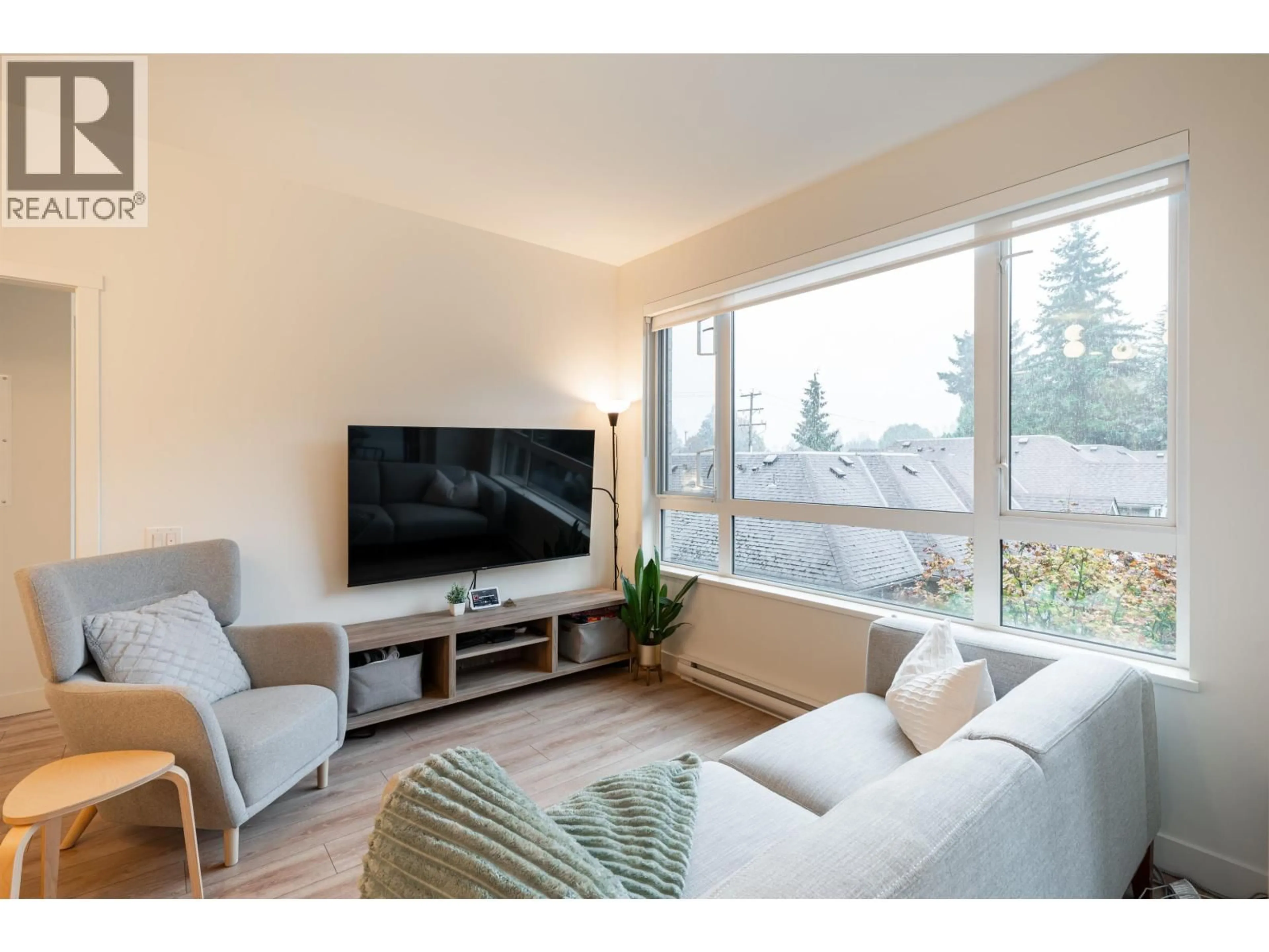 Living room with furniture, wood/laminate floor for 310 - 741 ANSKAR COURT, Coquitlam British Columbia V3J0N3