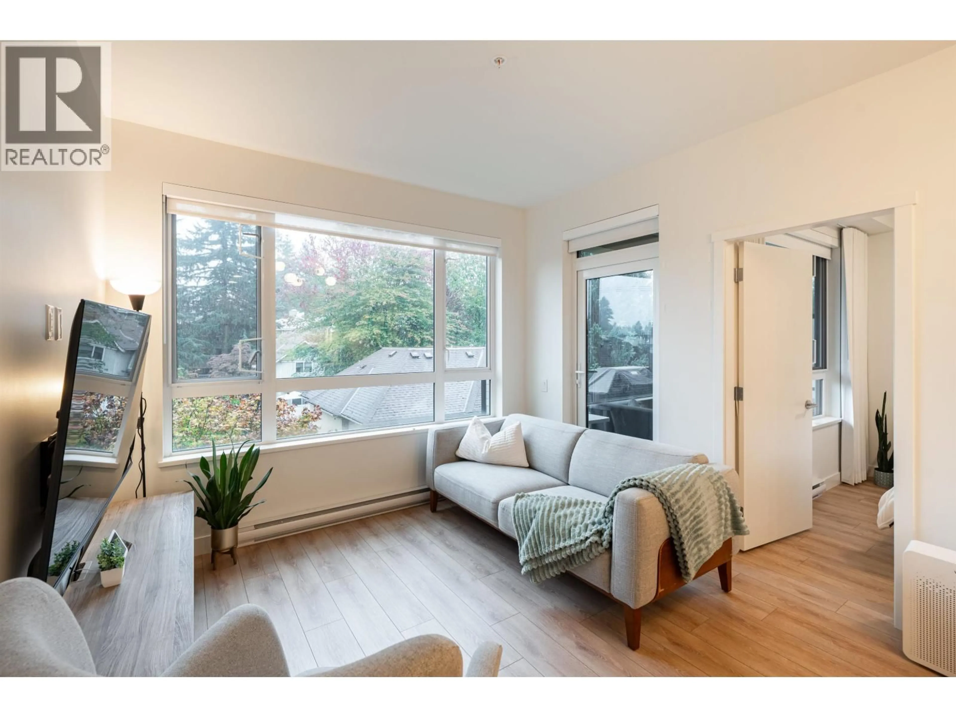 Living room with furniture, wood/laminate floor for 310 - 741 ANSKAR COURT, Coquitlam British Columbia V3J0N3