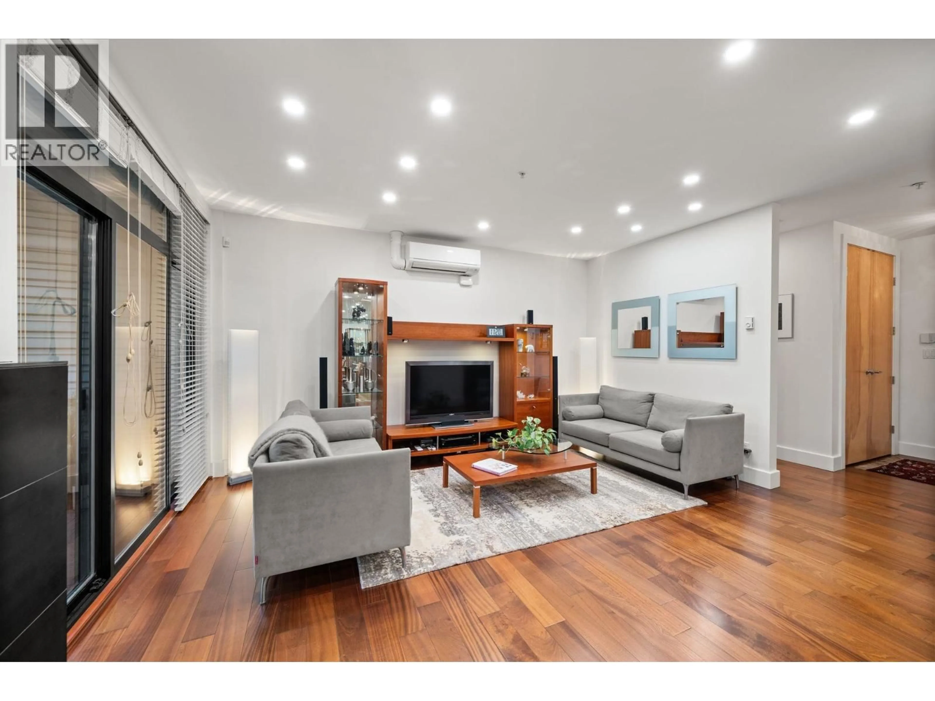 Living room with furniture, wood/laminate floor for 202 - 1750 2ND AVENUE, Vancouver British Columbia V6J1H6