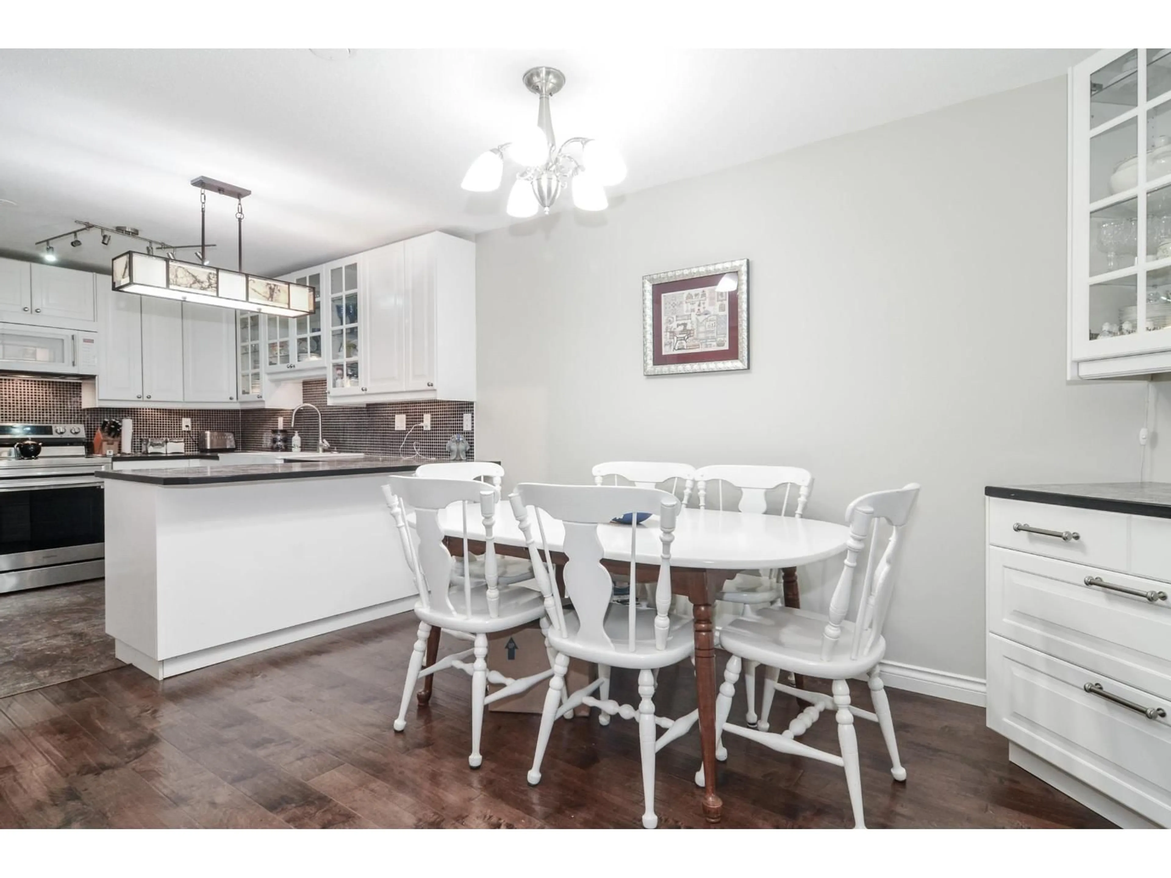 Dining room, wood/laminate floor for 105 - 13894 102, Surrey British Columbia V3T1P1