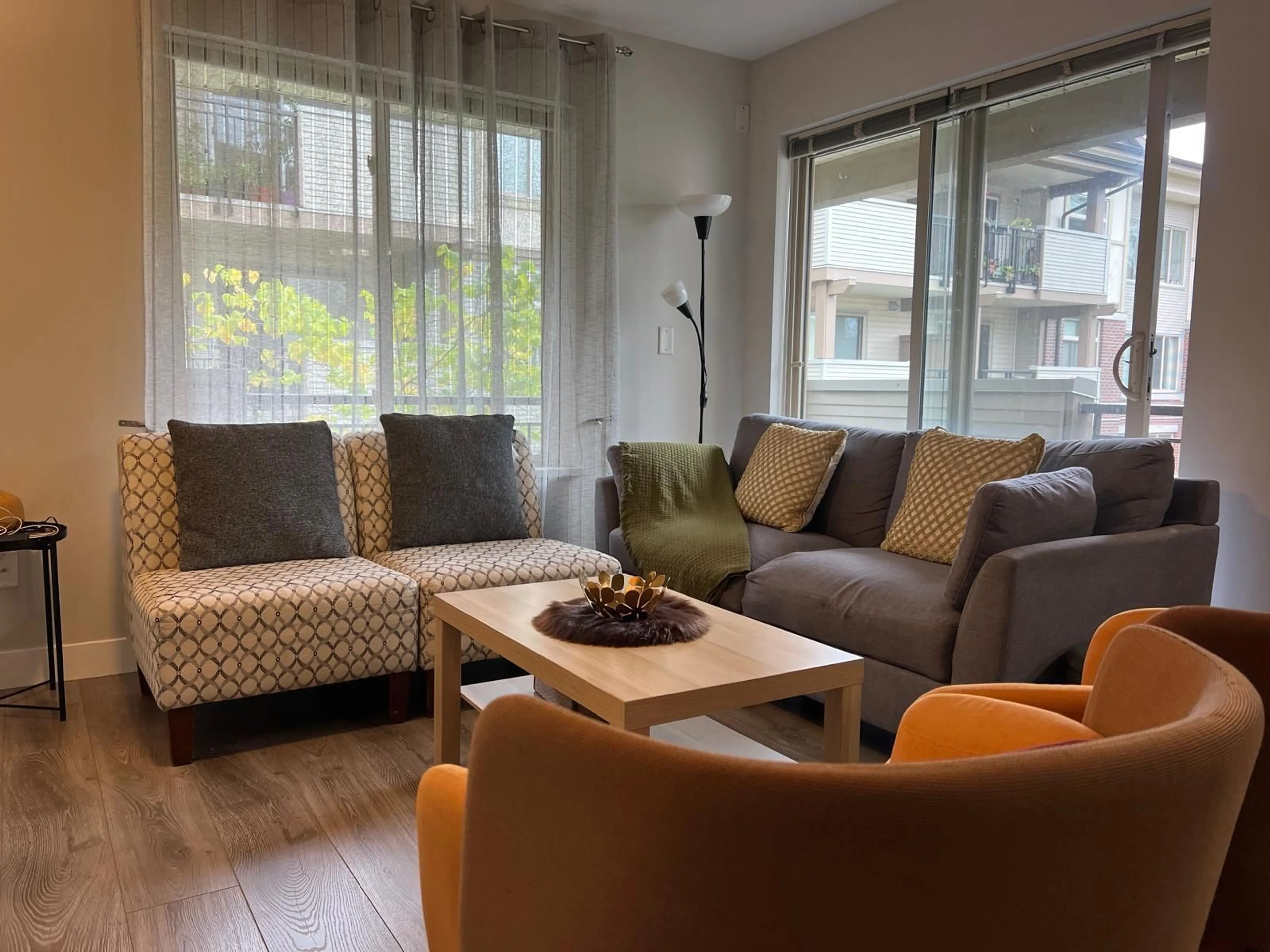 Living room with furniture, wood/laminate floor for 302 - 10092 148, Surrey British Columbia V3R4G7