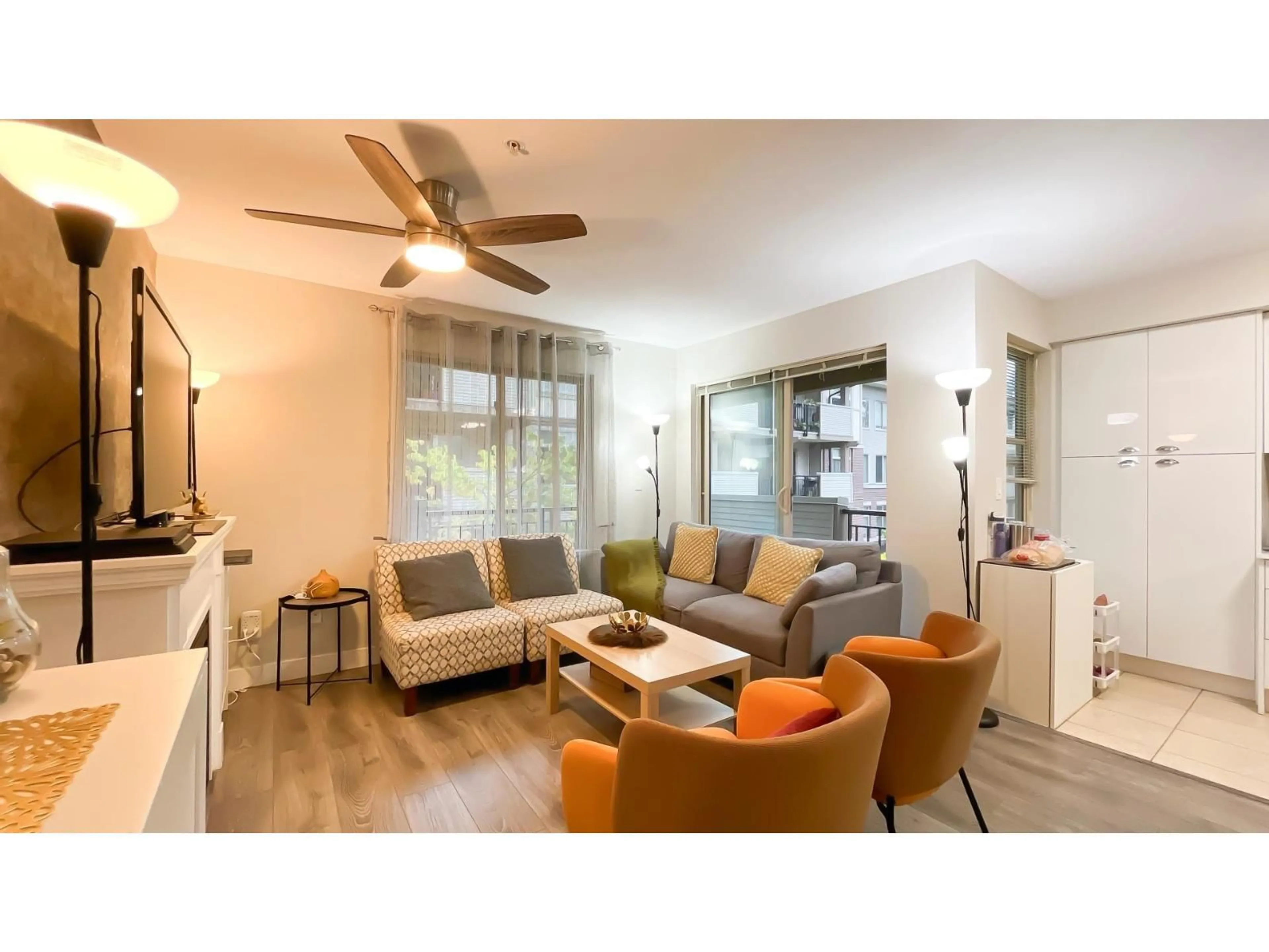 Living room with furniture, wood/laminate floor for 302 - 10092 148, Surrey British Columbia V3R4G7