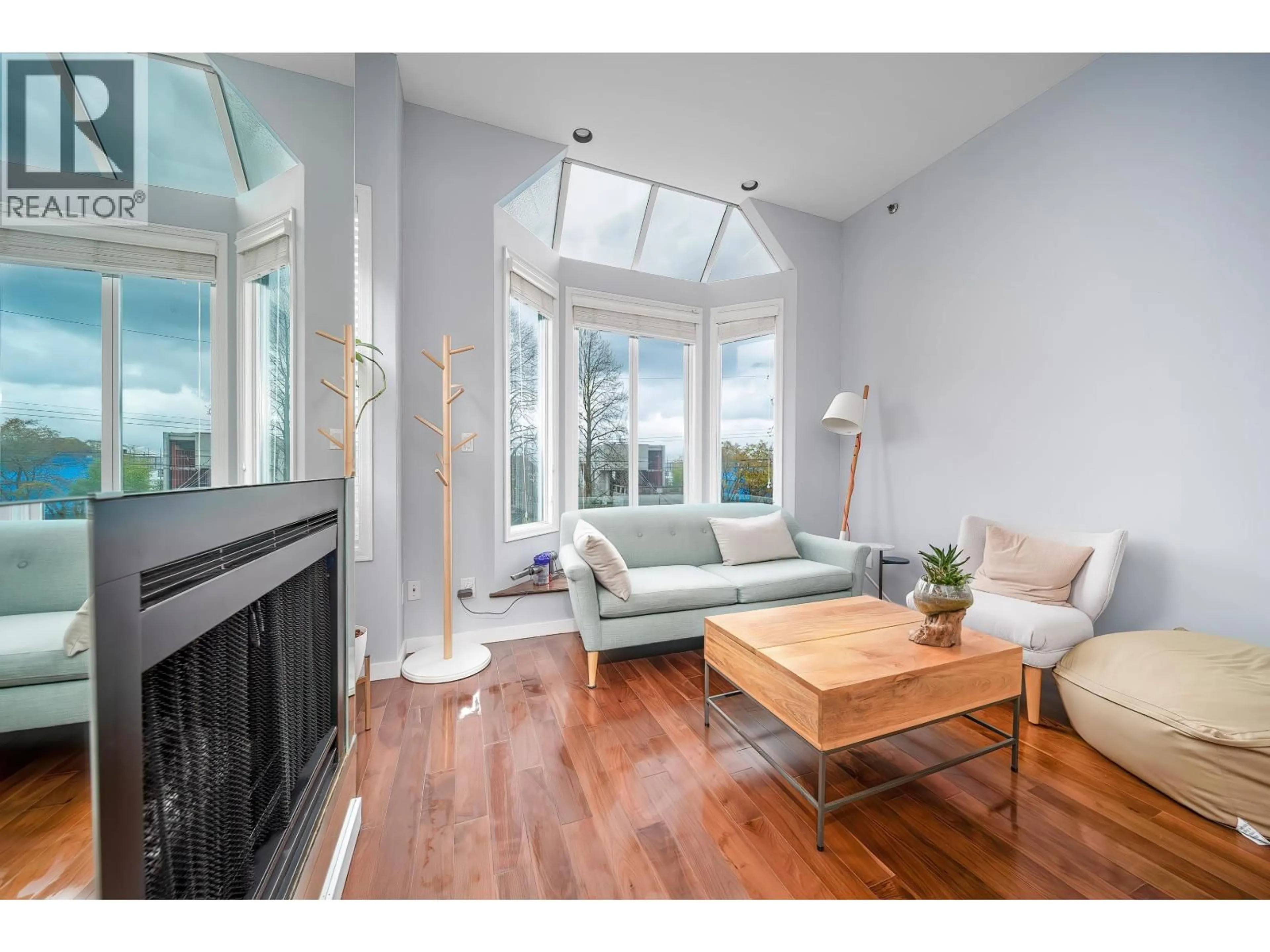 Living room with furniture, wood/laminate floor for 3458 POINT GREY ROAD, Vancouver British Columbia V6R1A5
