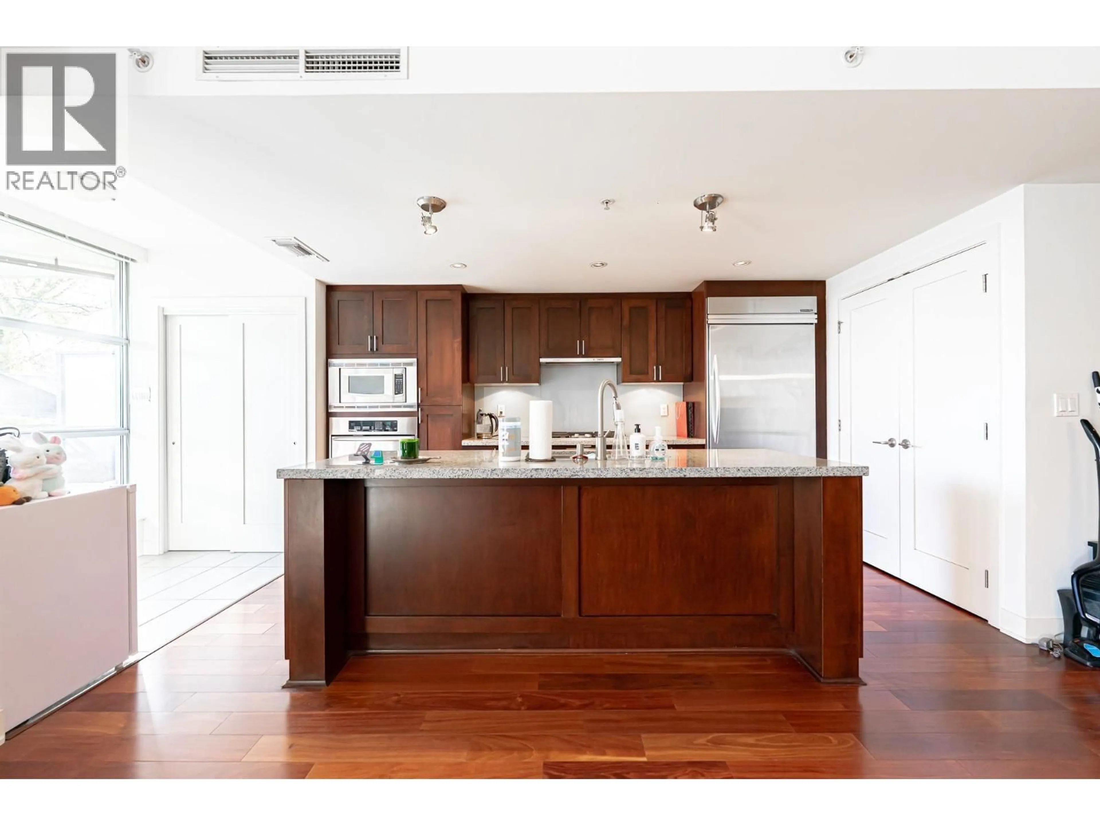 Open concept kitchen, wood/laminate floor for 104 - 3595 18TH AVENUE, Vancouver British Columbia V6S1A9