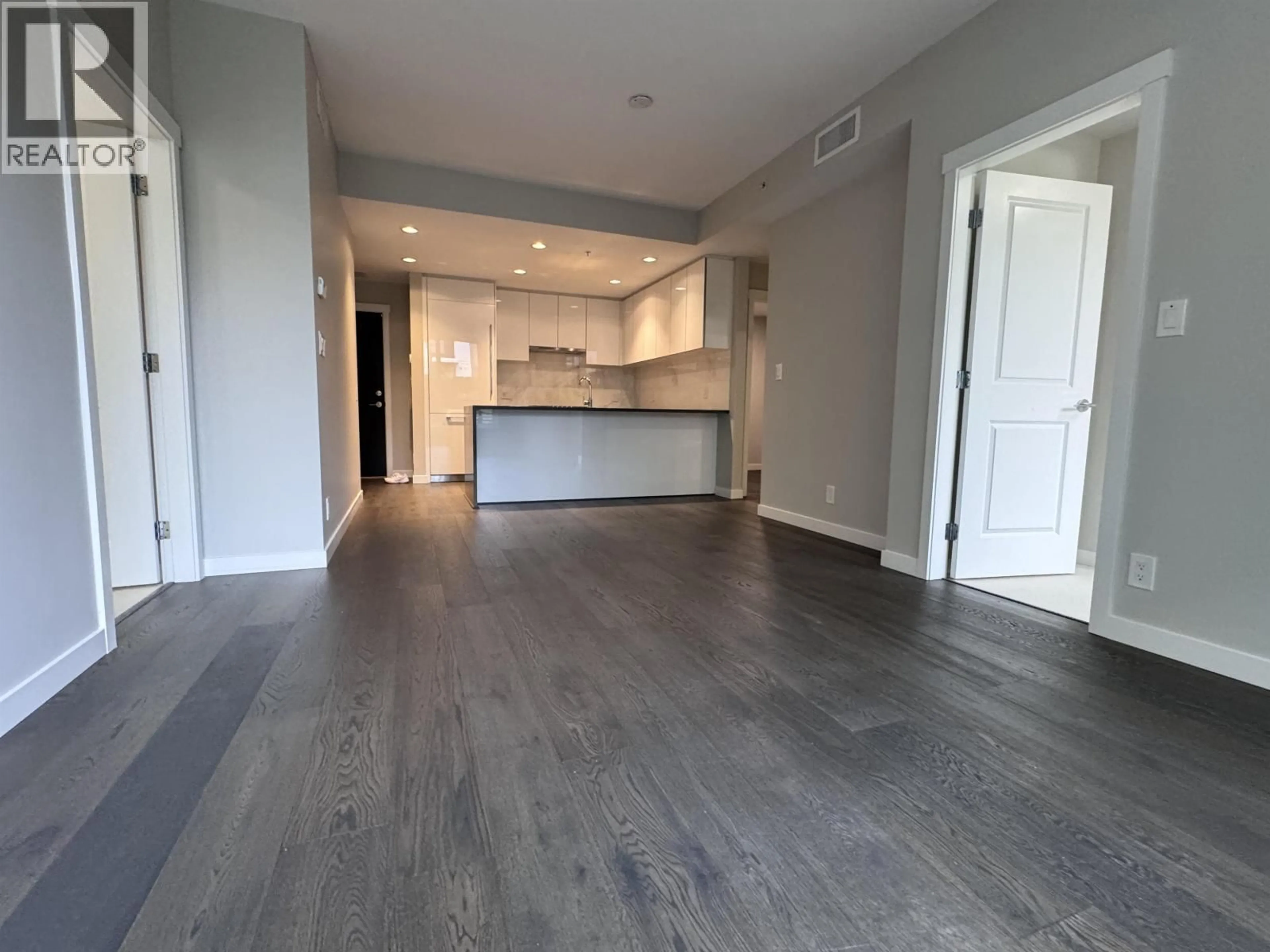 Open concept kitchen, wood/laminate floor for 102 - 5687 GRAY AVENUE, Vancouver British Columbia V6S0K7